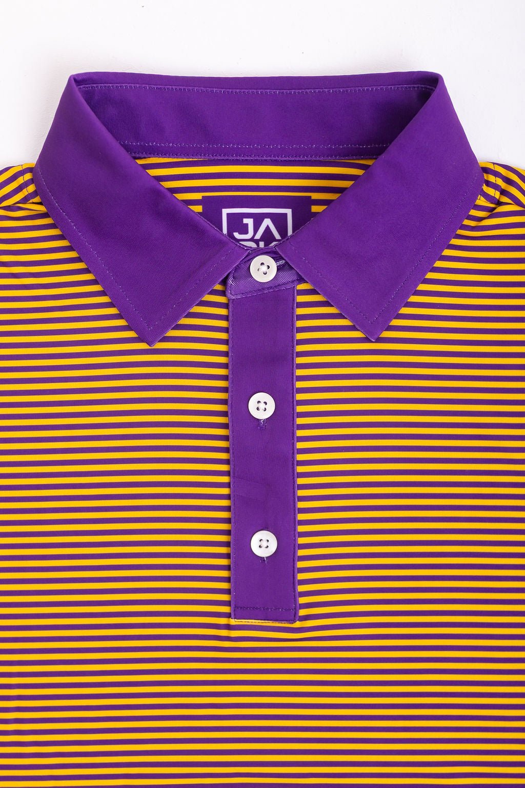 Purple and yellow striped polo shirt with a collar and buttons on a white background