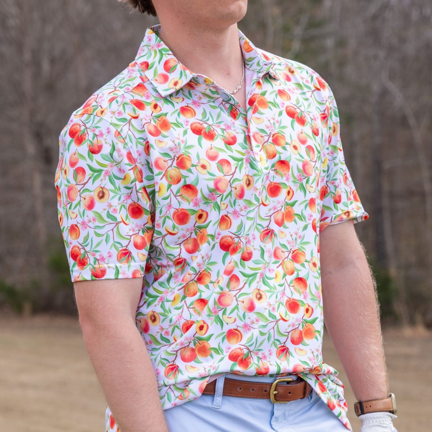 Person wearing a colorful fruit patterned shirt outdoors