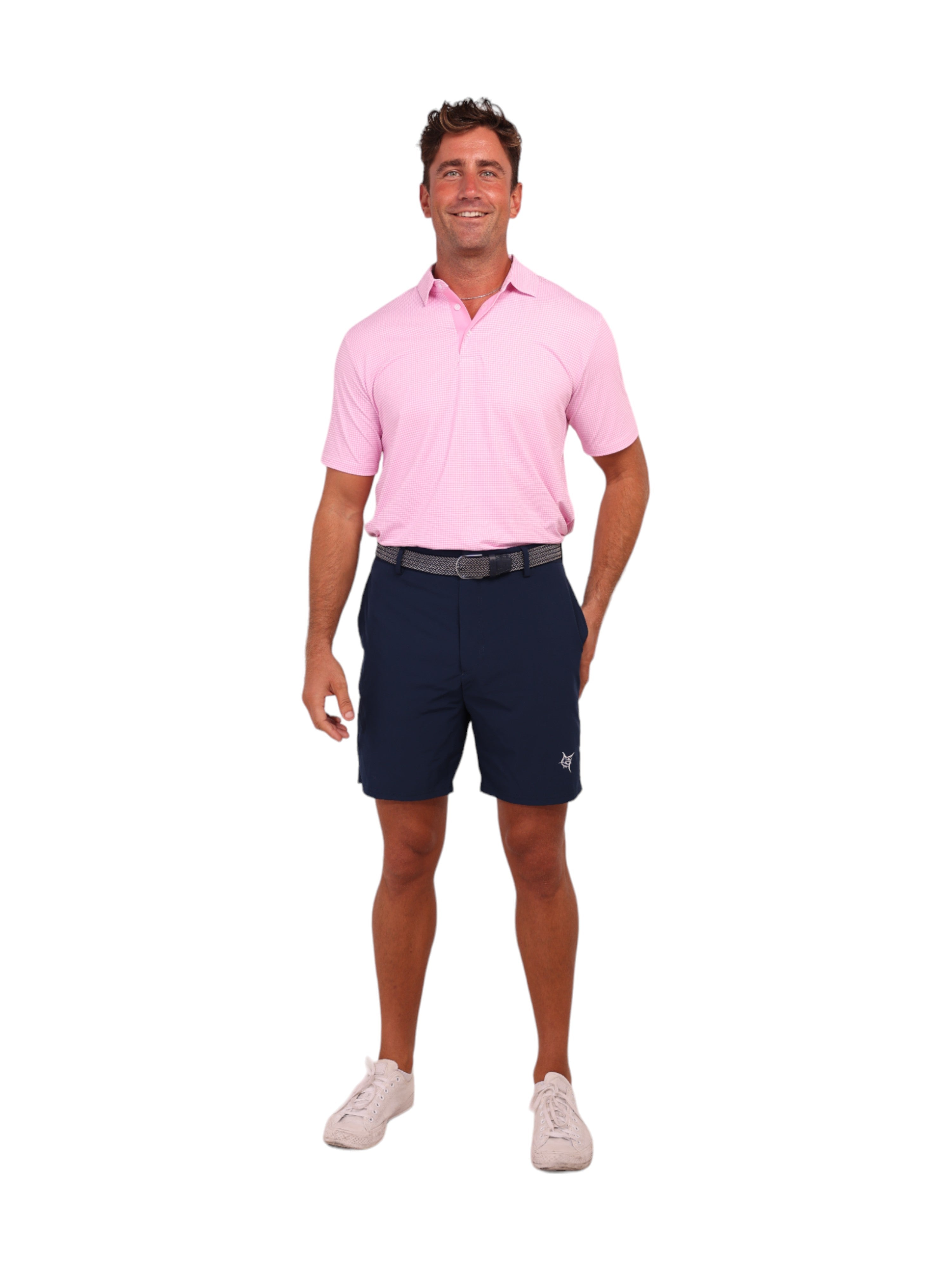 Man wearing a pink shirt and navy shorts on a white background