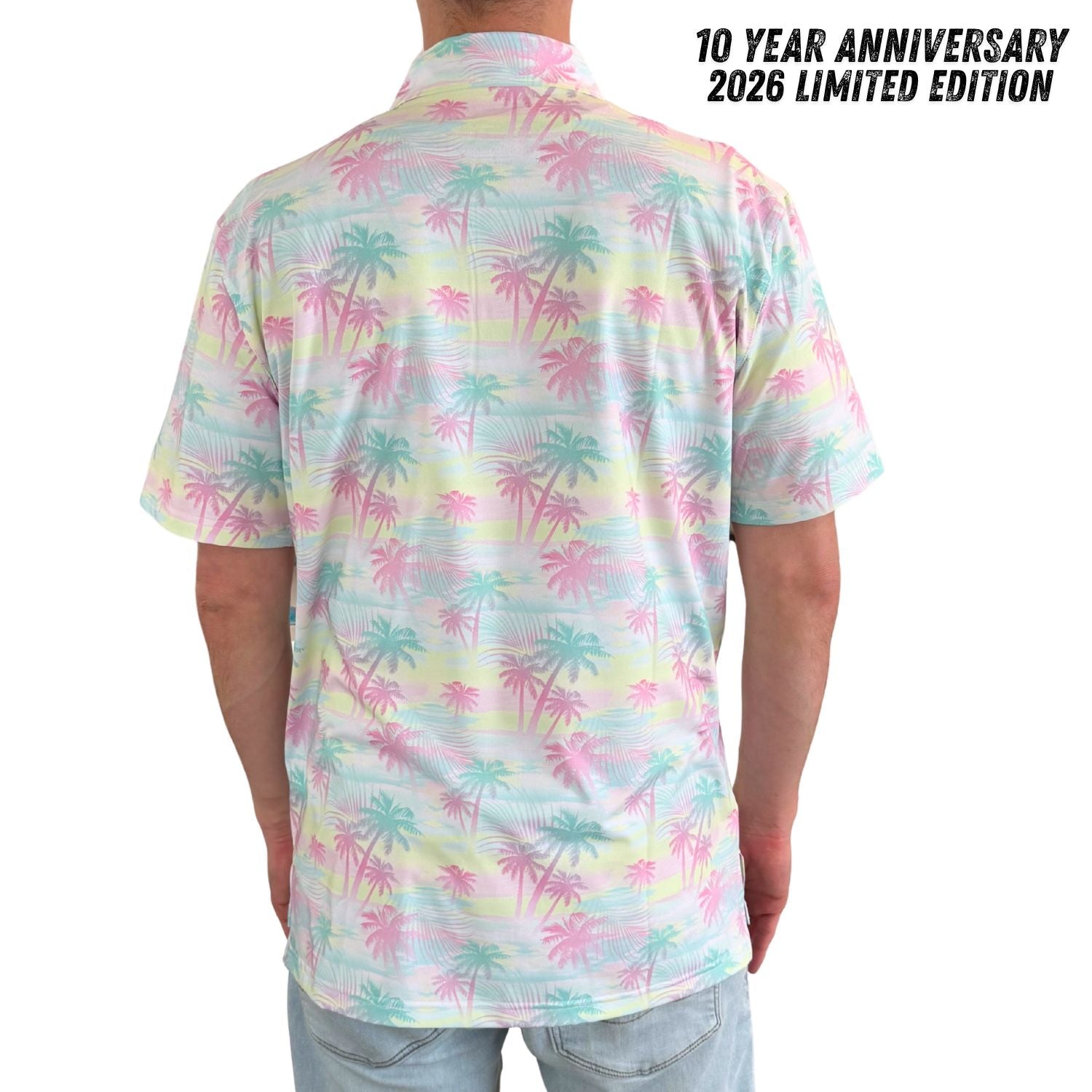 Person wearing a colorful palm tree pattern shirt with text indicating a 10-year anniversary.