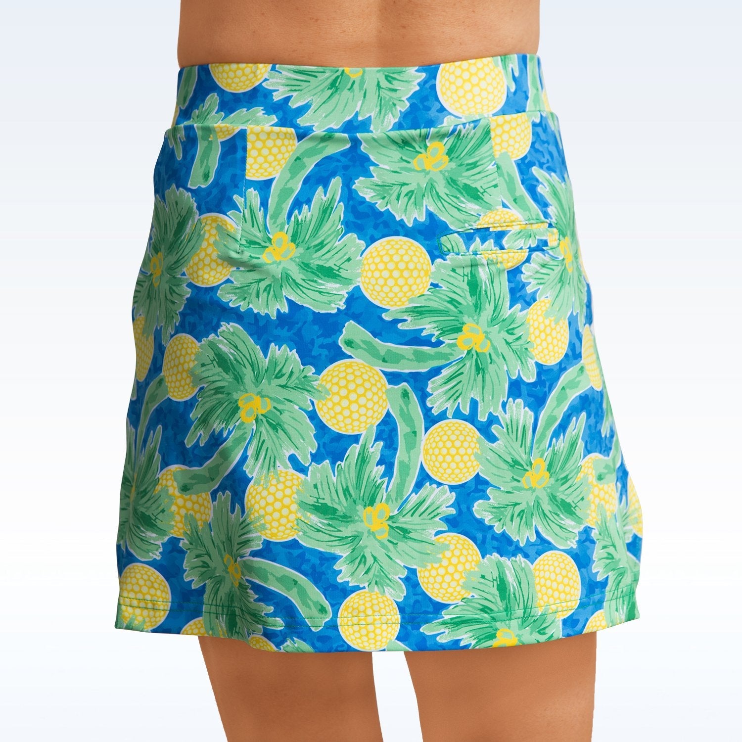 Blue skirt with pineapple and palm tree pattern on a white background