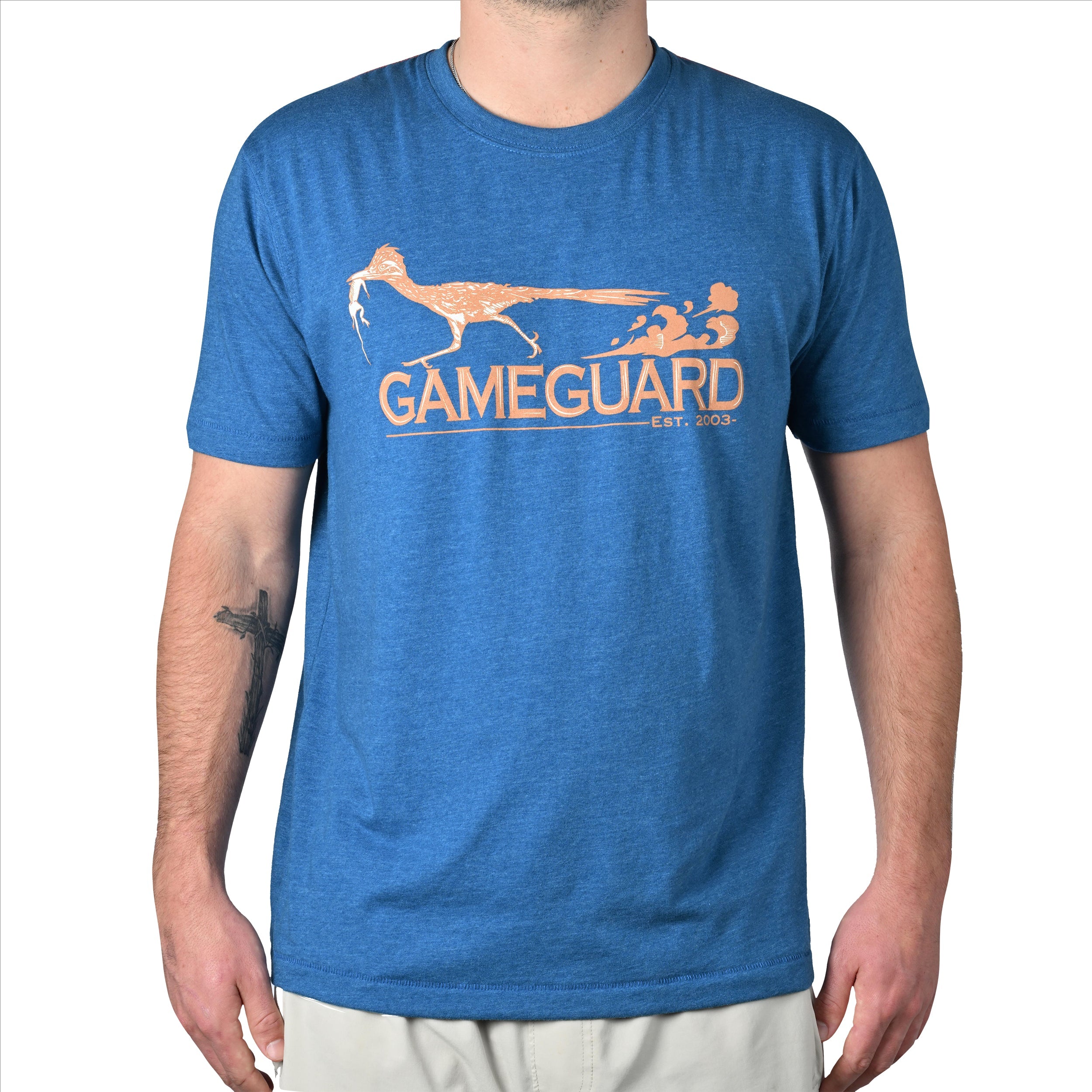 Blue t-shirt with 'GAMEGUARD' logo worn by a person on a white background