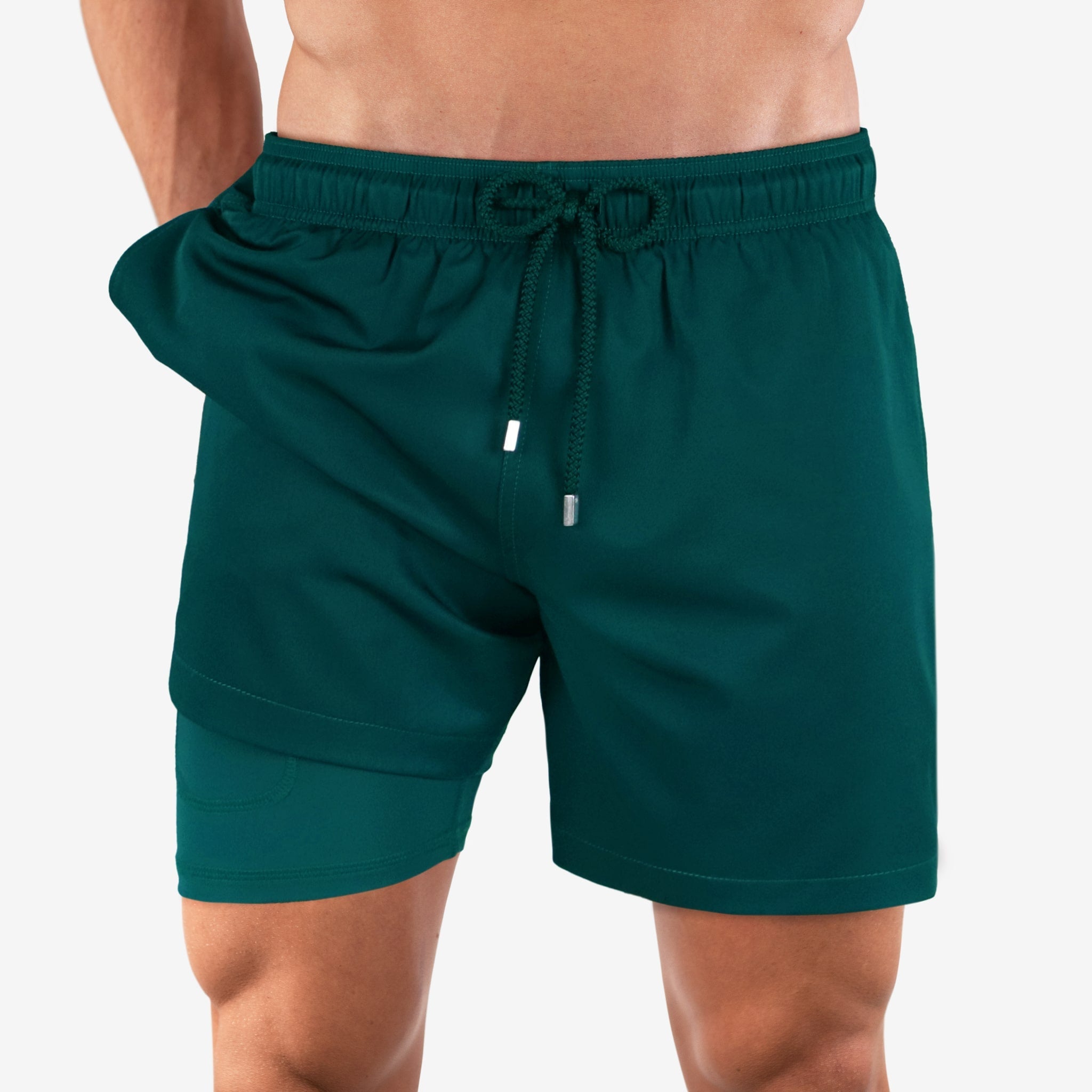 Green shorts worn by a person on a white background
