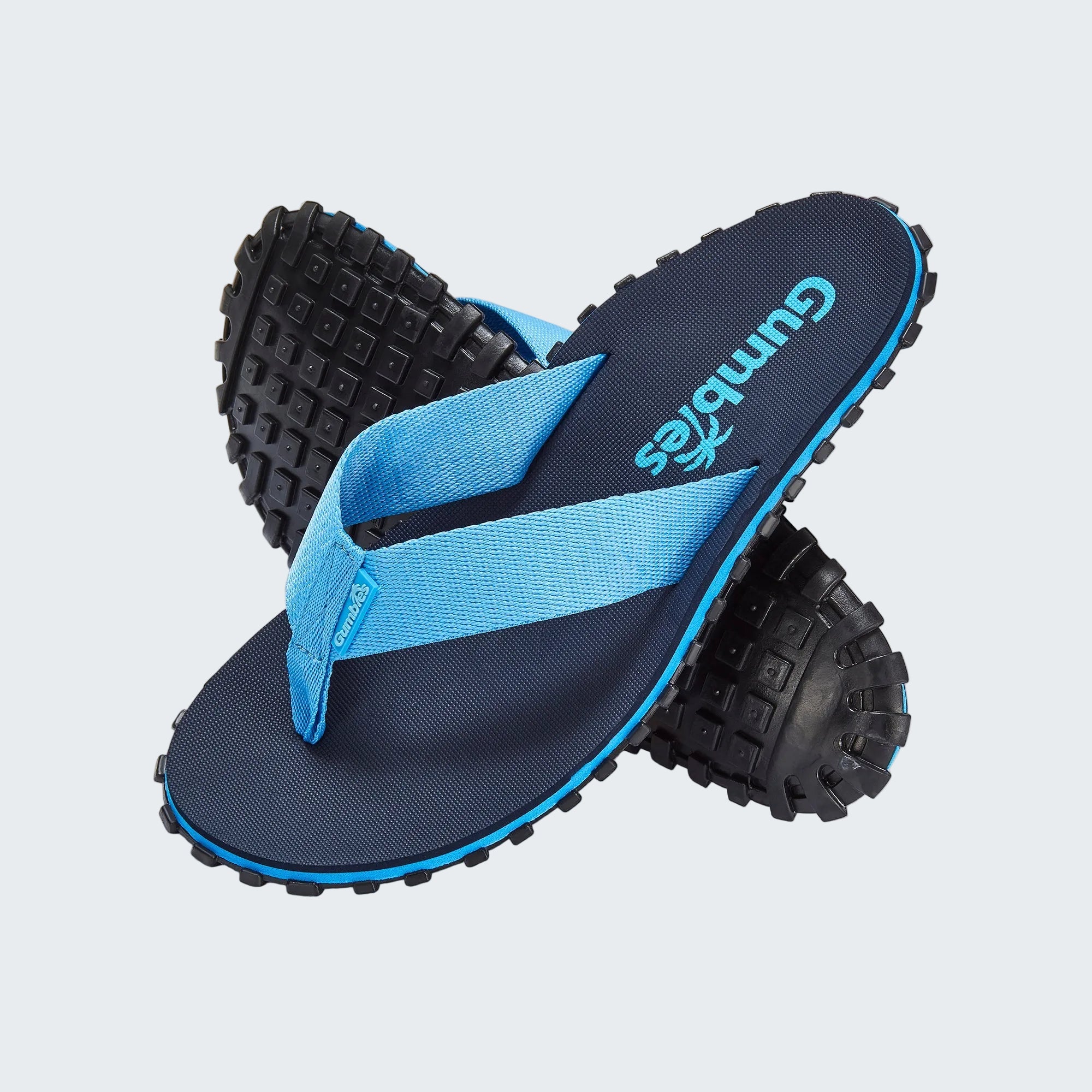 Blue and black flip-flops with textured sole on a white background
