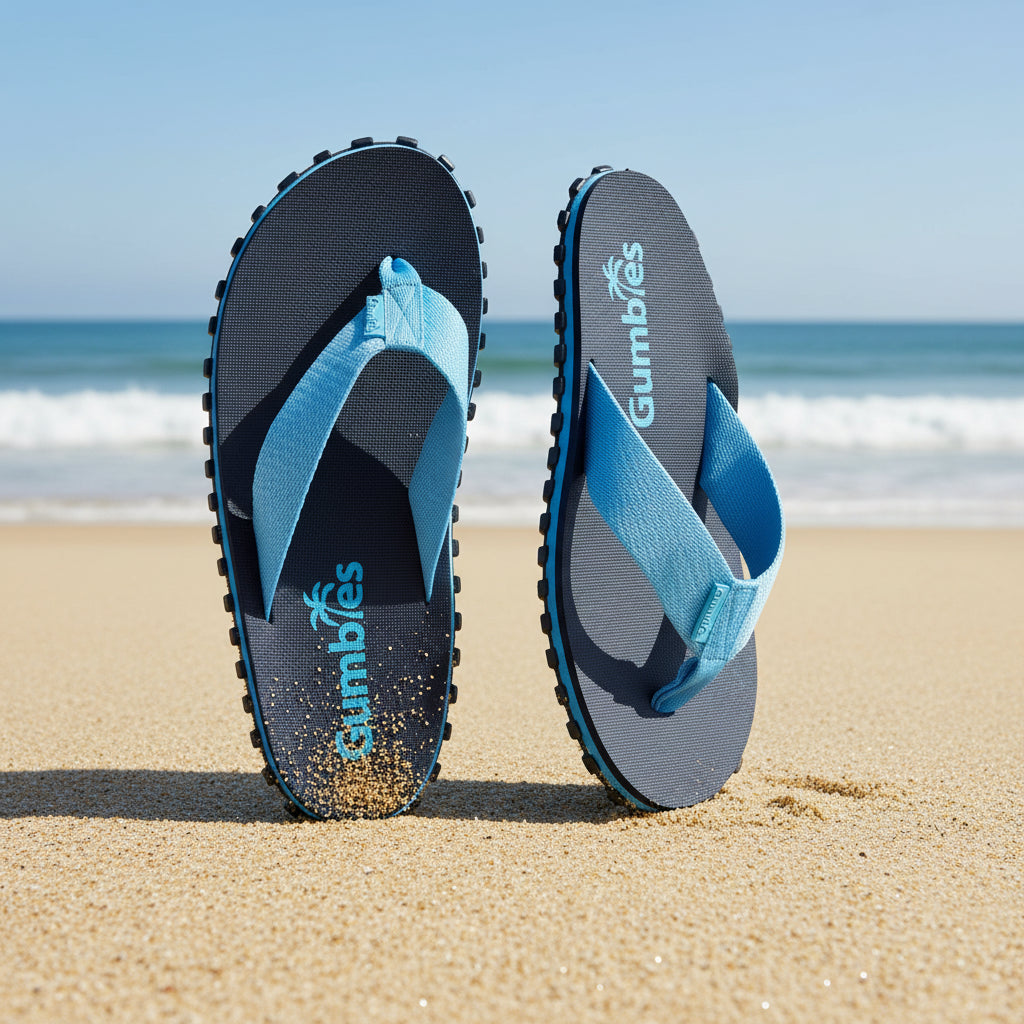 Blue and black flip-flops with 'Gumbies' branding on a white background