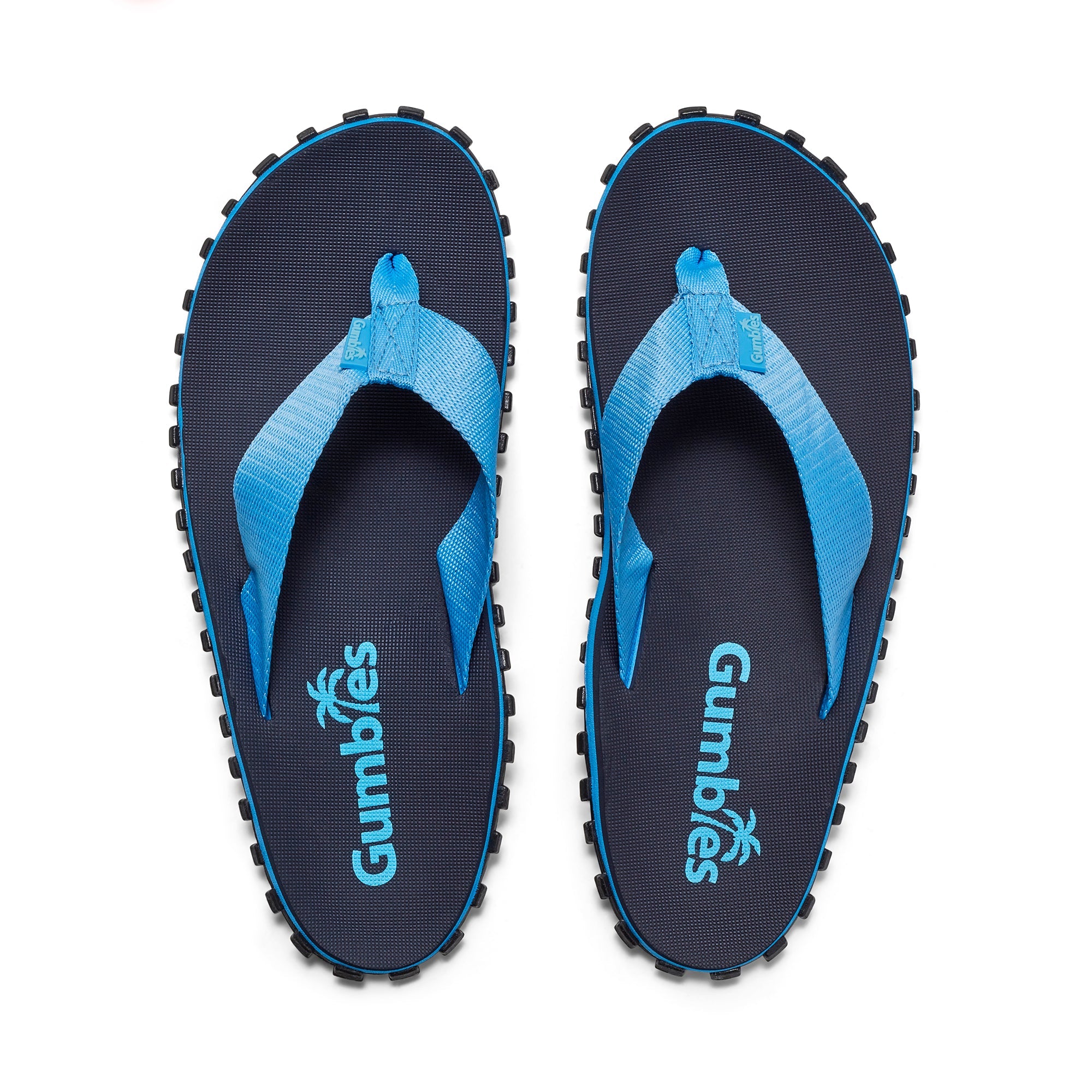 Pair of blue and black Gumbies sandals on a white background