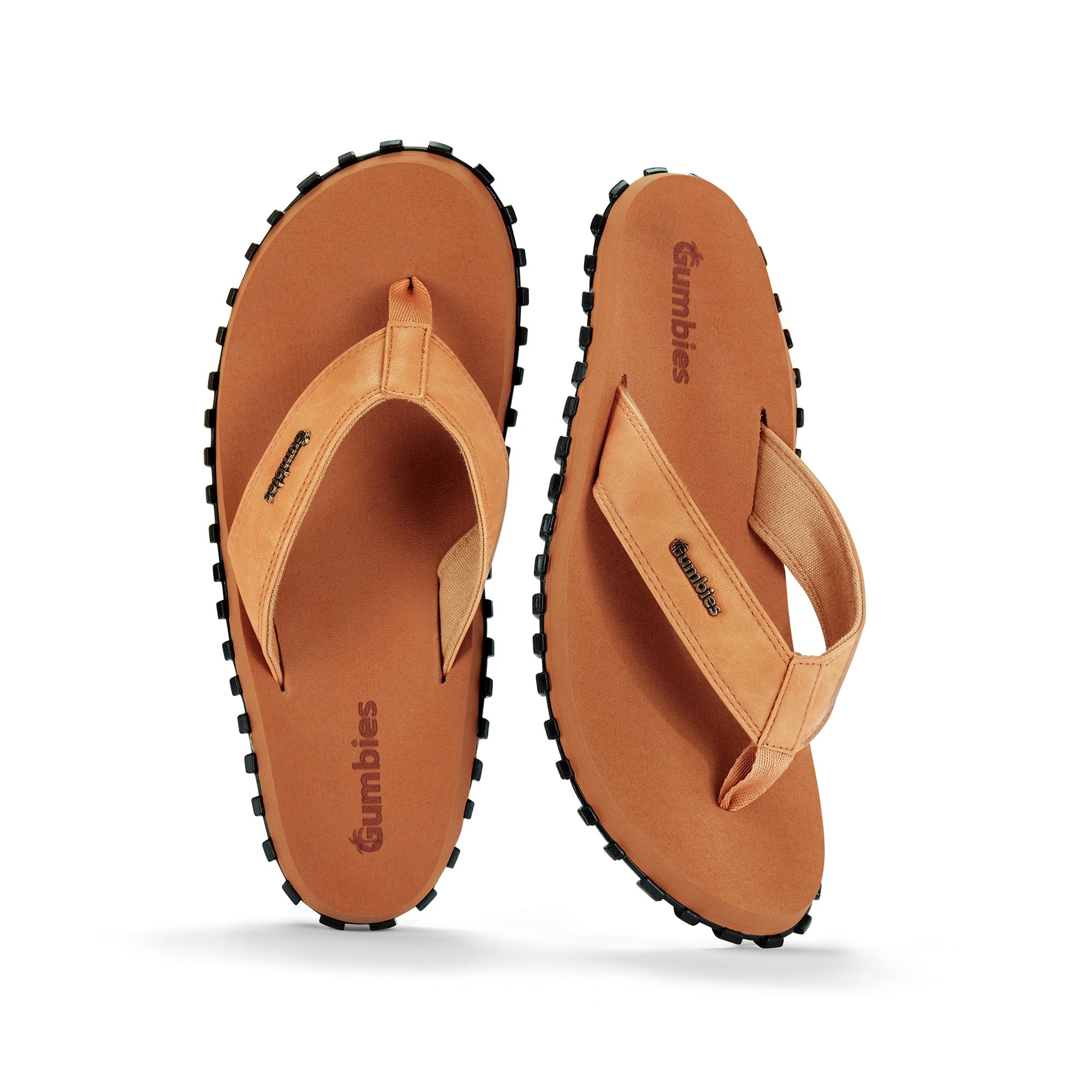 Pair of tan sandals with black soles on a white background