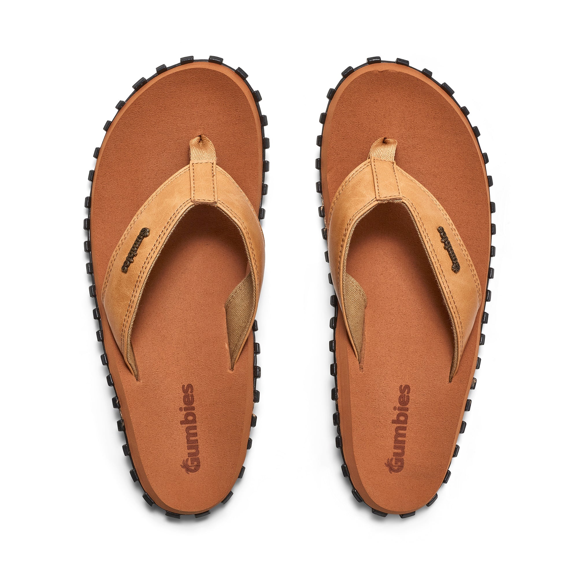 Pair of tan sandals with black soles on a white background