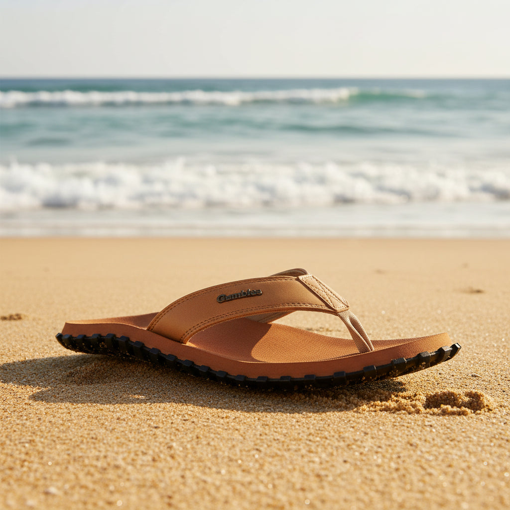 Brown sandal with black sole on a white background