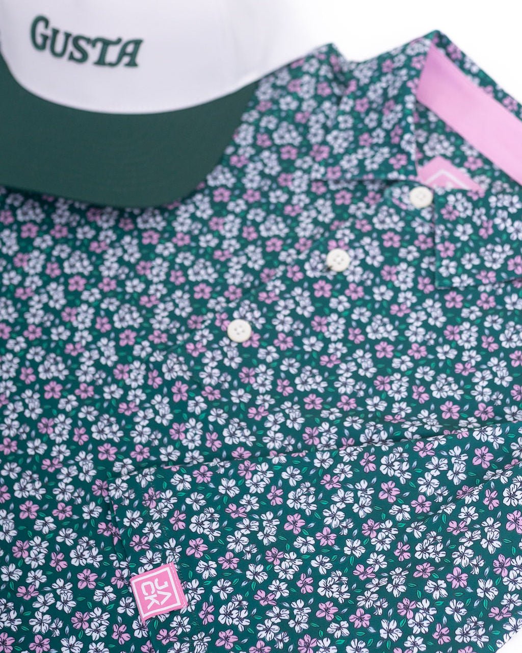 Floral patterned shirt with visible brand logo on a green background