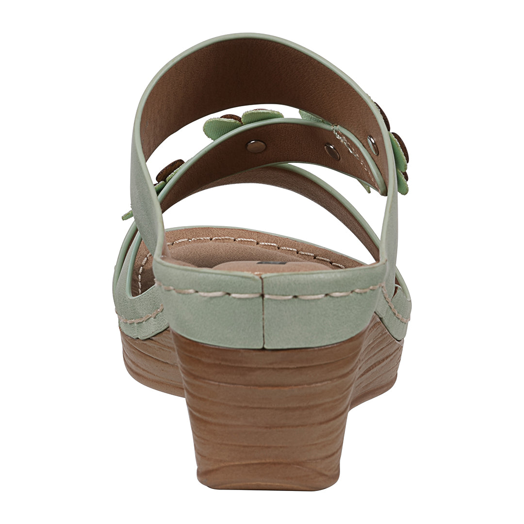 Light green sandal with a brown sole on a white background