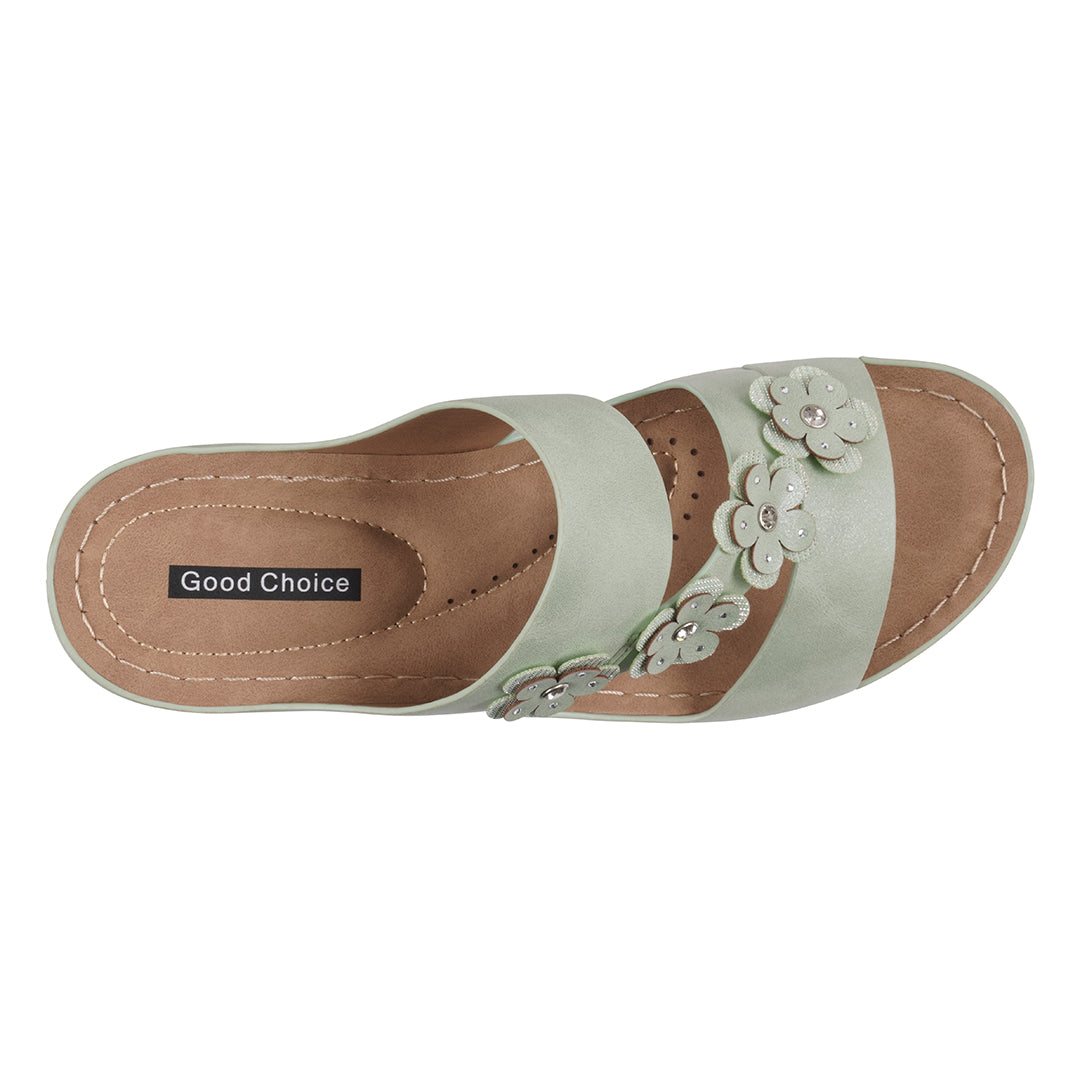 Light green sandal with floral decorations on a white background