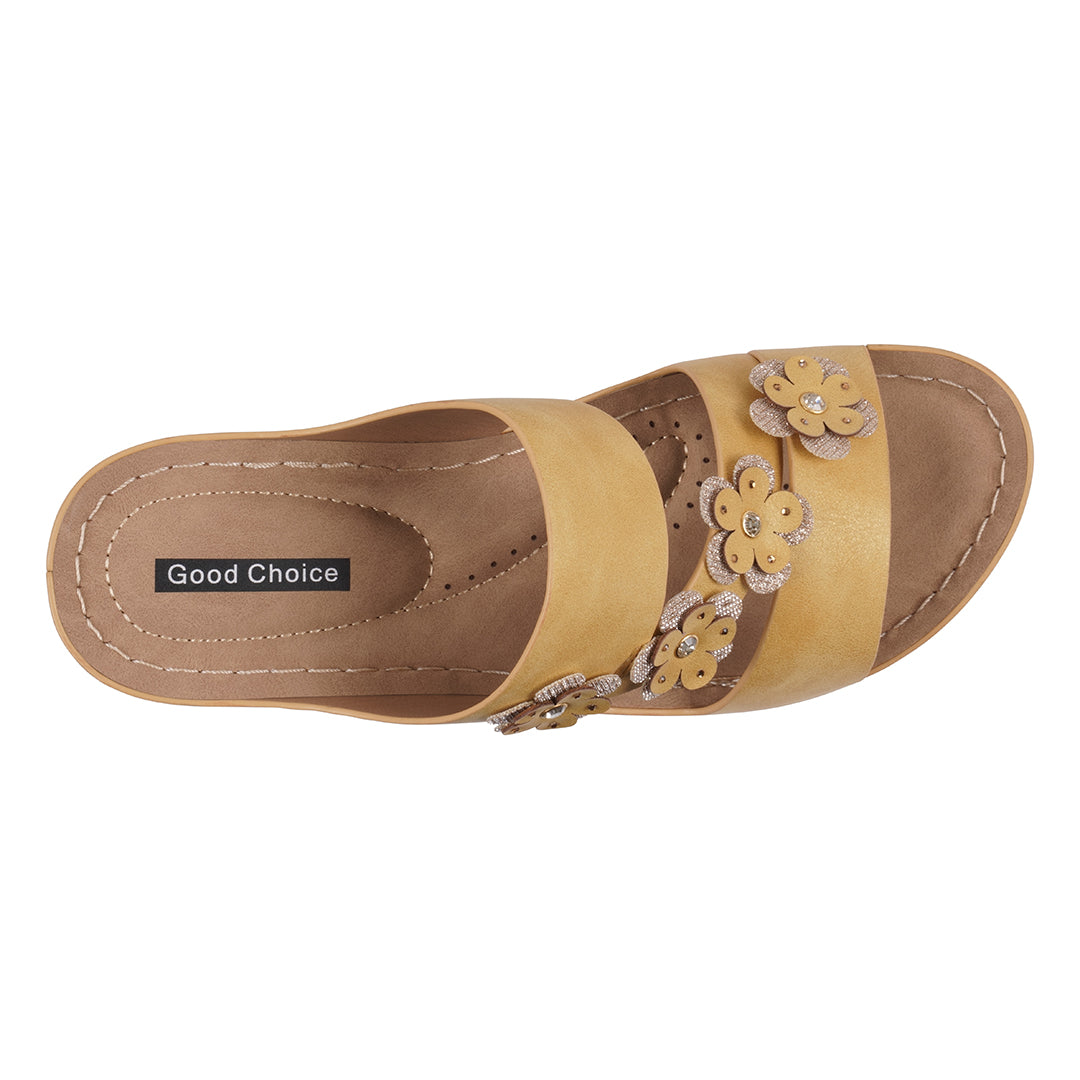 Tan sandal with floral designs on a white background