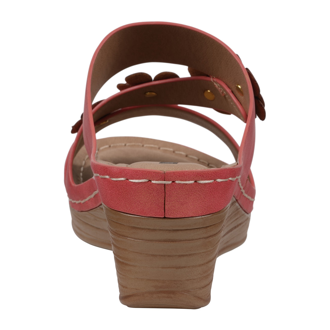 Red sandal with a brown wedge sole on a white background