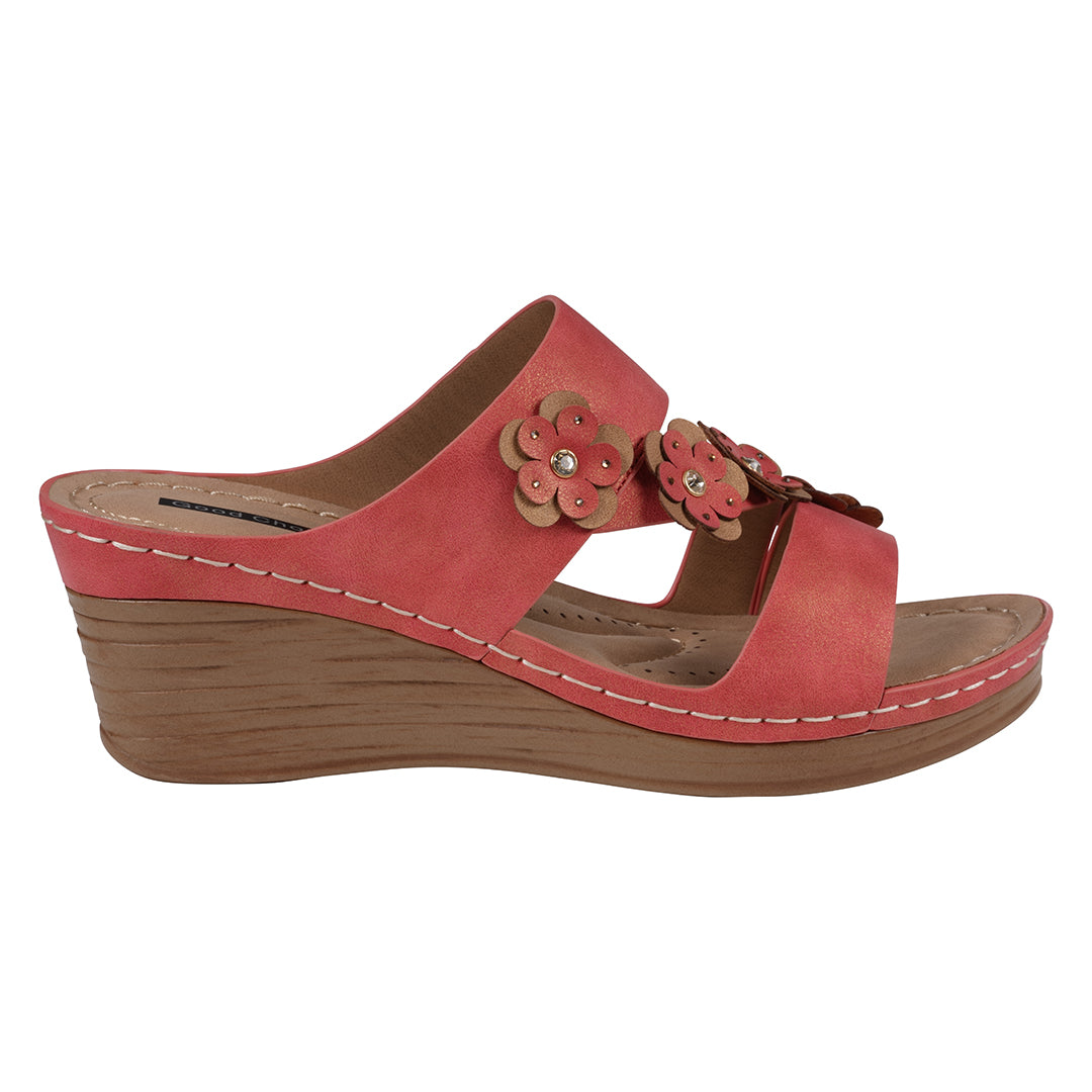 Red wedge sandal with floral decorations on a white background