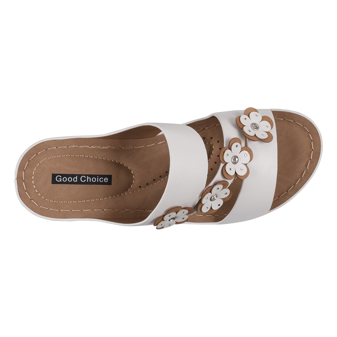 White sandal with floral designs on a white background