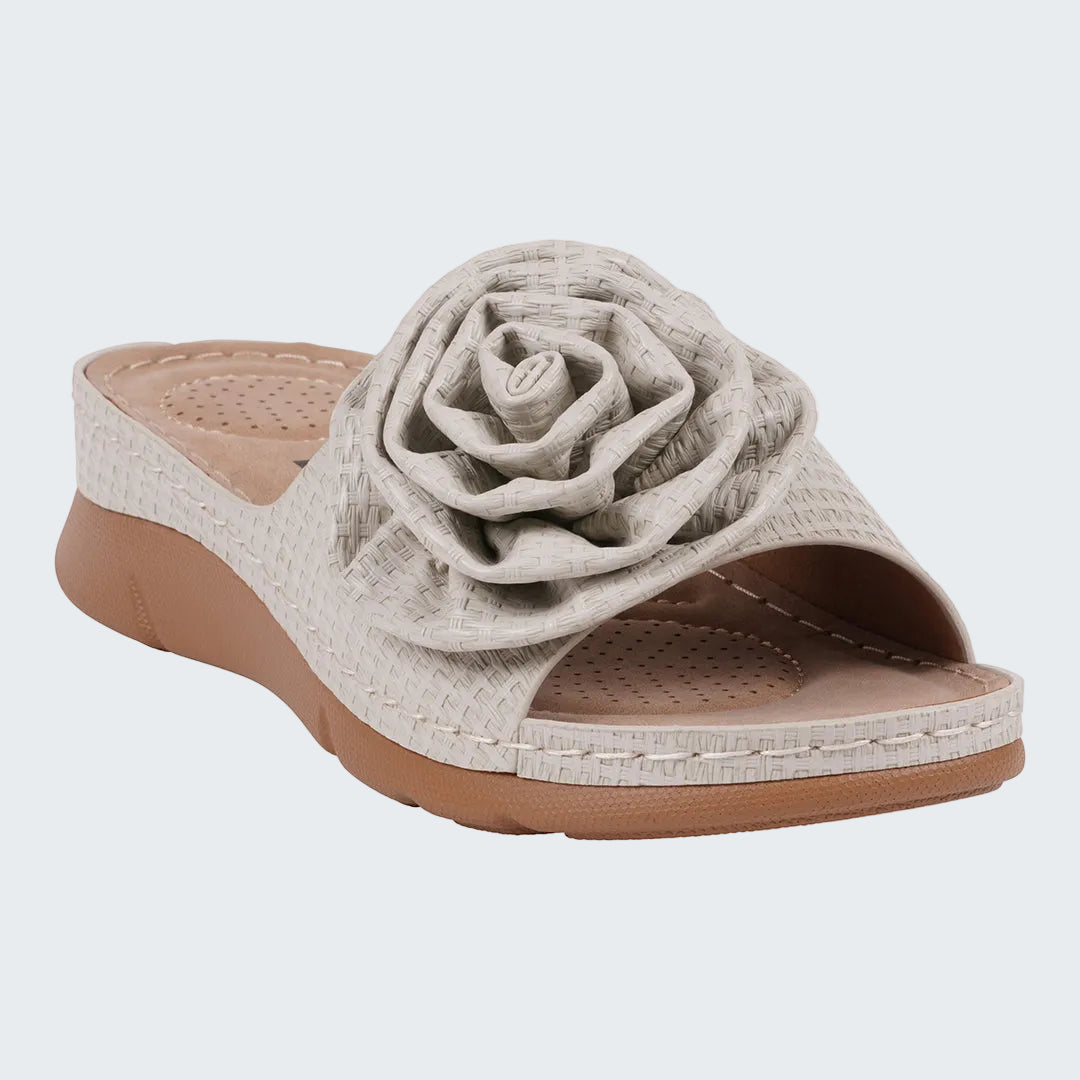 Beige sandal with a floral design on a white background