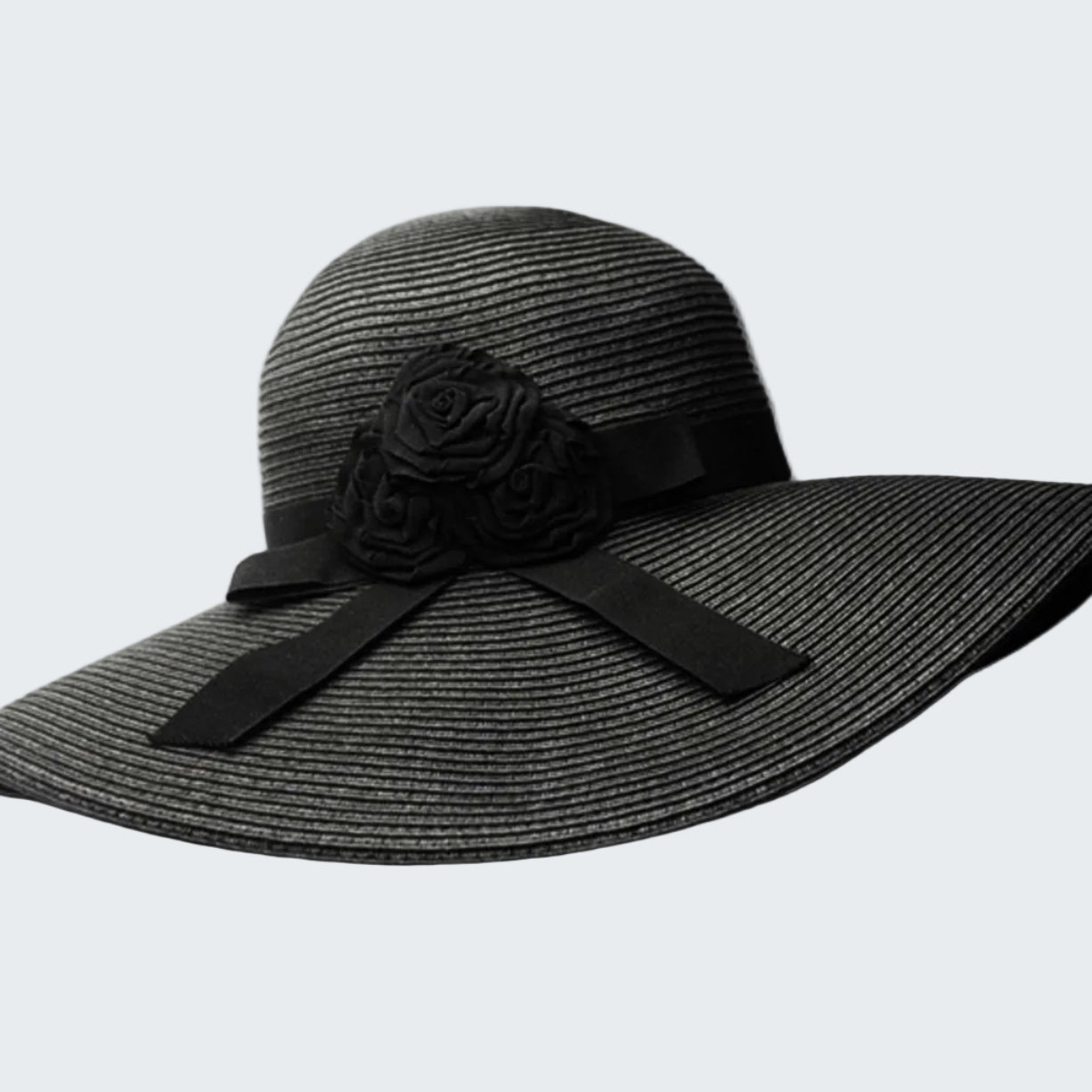 Black straw hat with a flower and bow on a white background