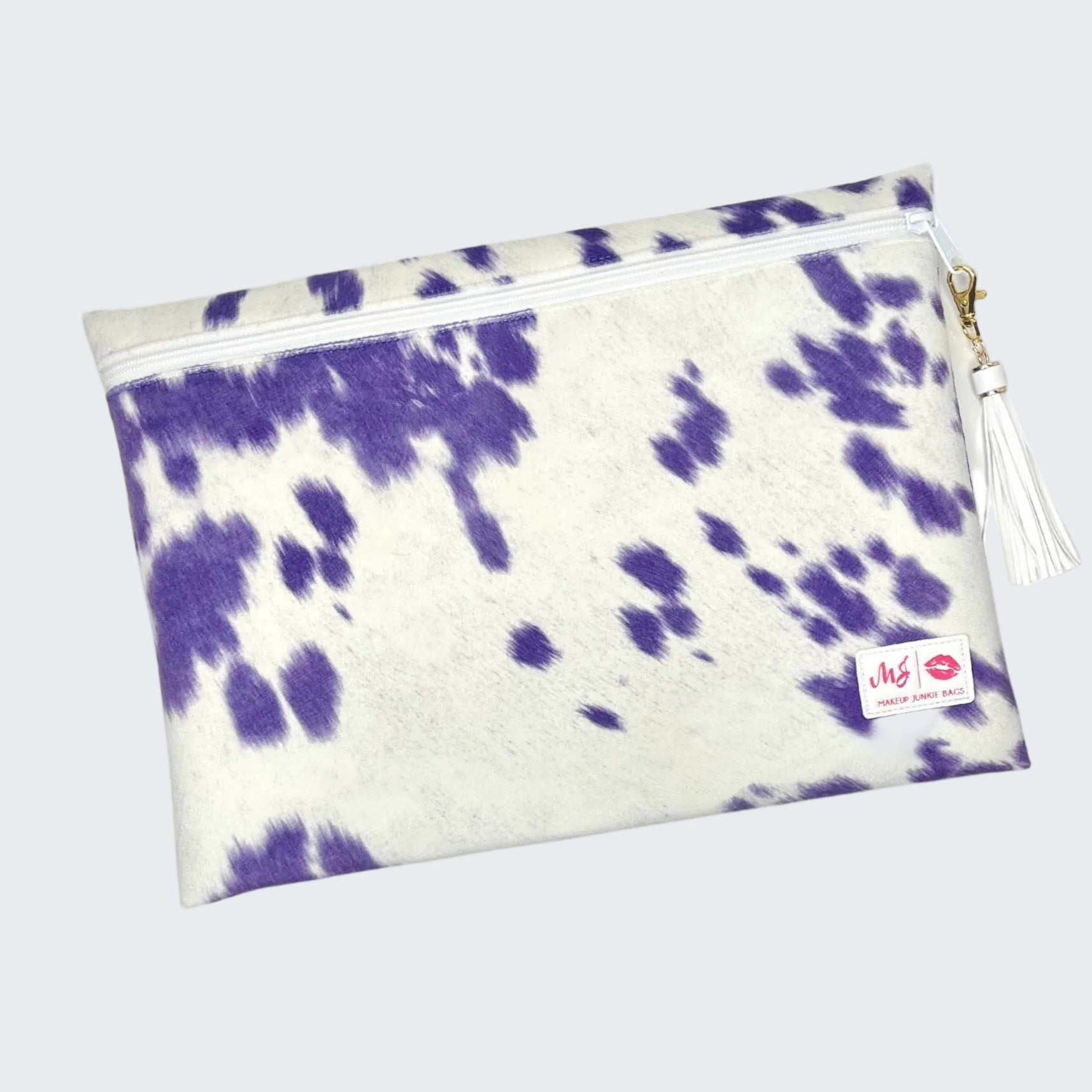 Purple and white tie-dye pouch with a tassel on a white background