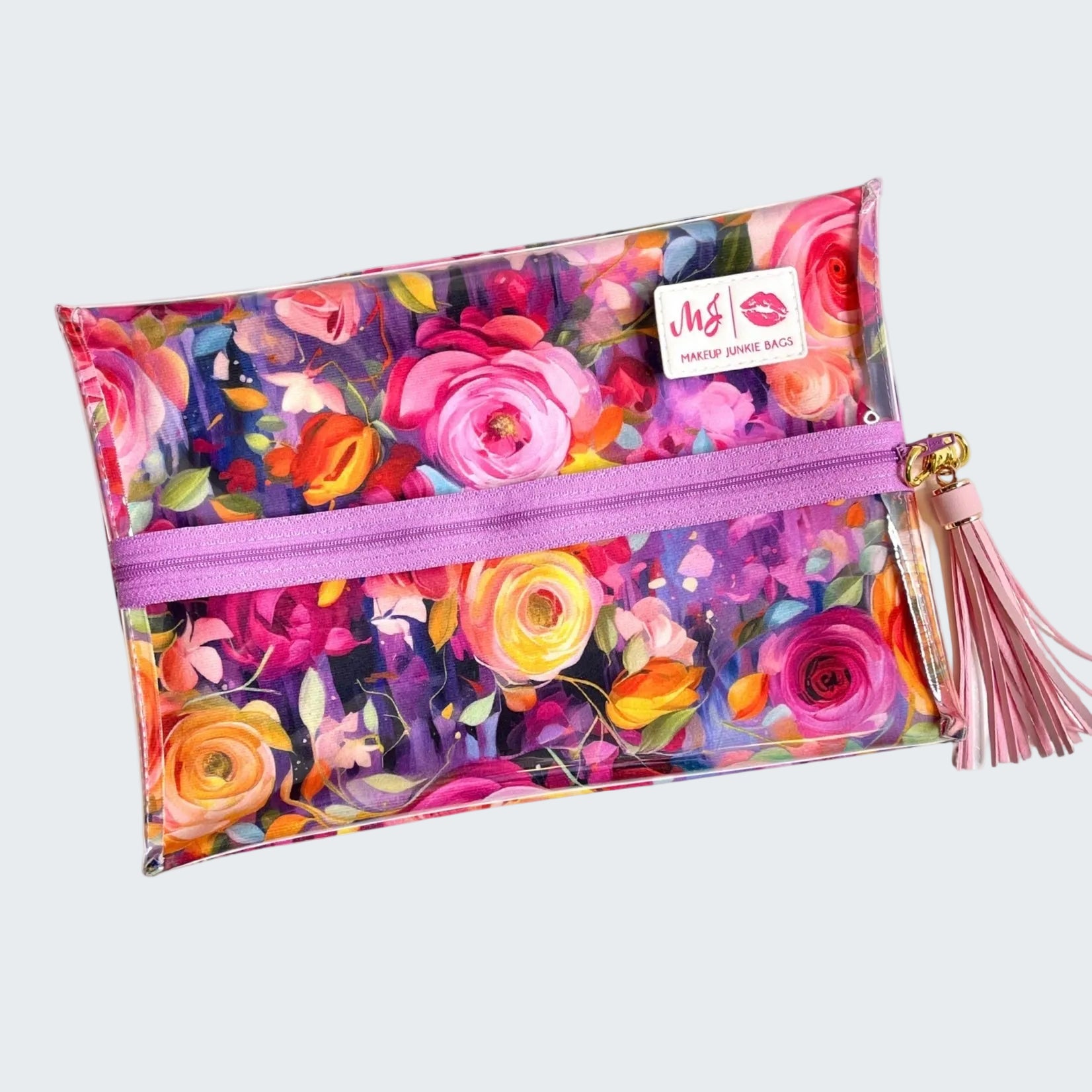 Colorful floral makeup bag with a pink zipper and tassel on a white background
