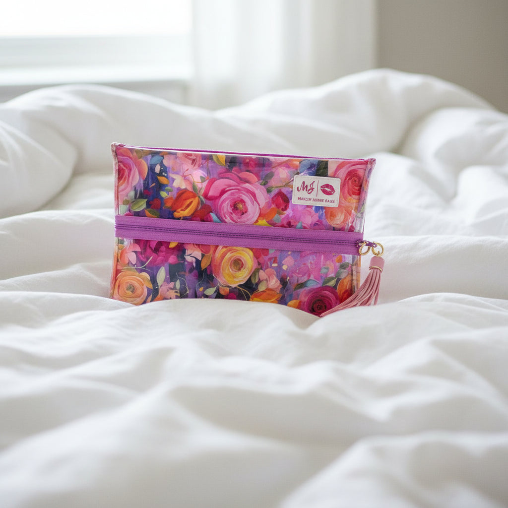 Floral makeup bag with a pink zipper and tassel on a white background