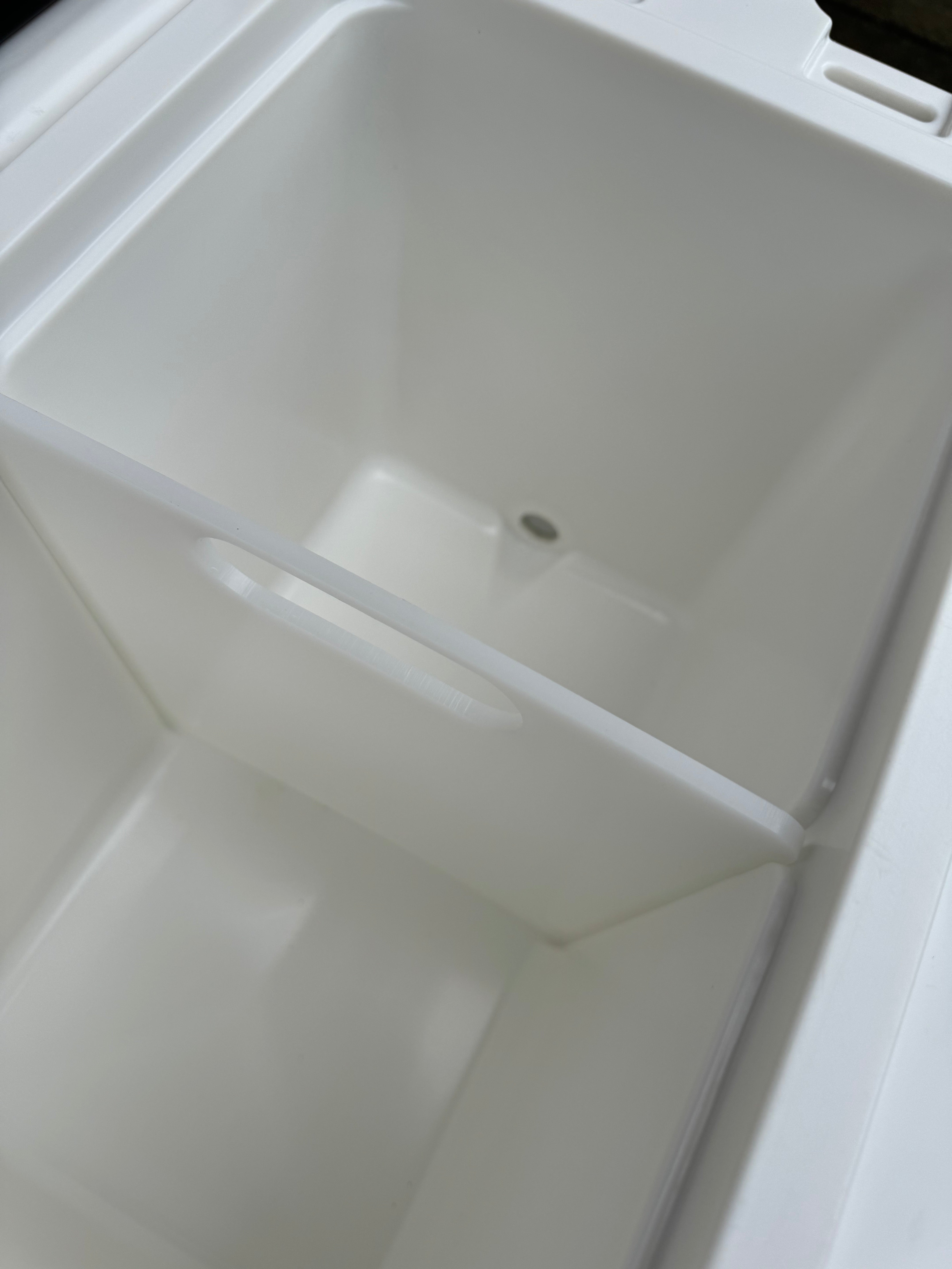 White plastic container with a lid on a white background