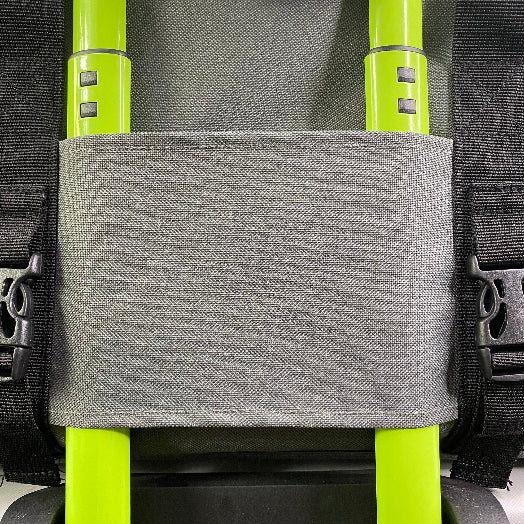 Gray pouch attached to a backpack with bright green straps