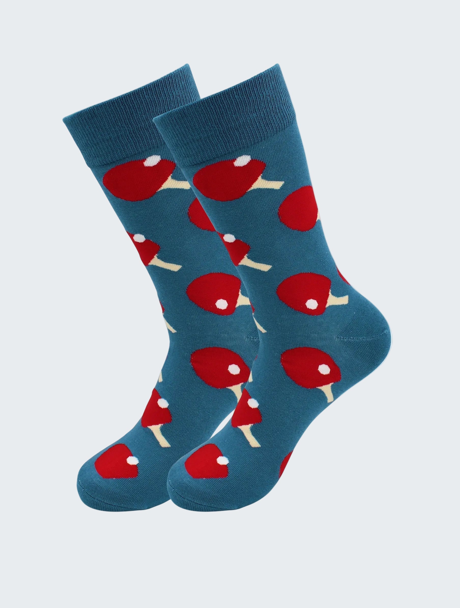 Blue socks with red and white ping pong ball pattern on a white background