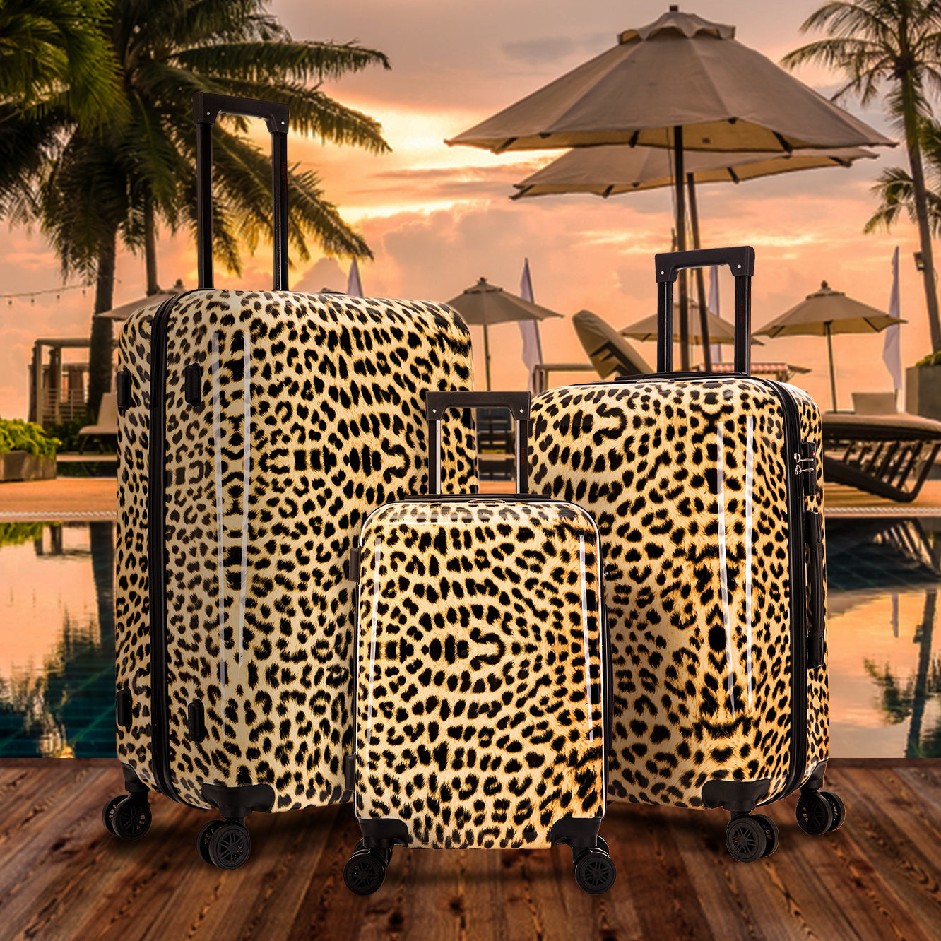 Leopard print suitcases by a poolside with sunset and palm trees in the background