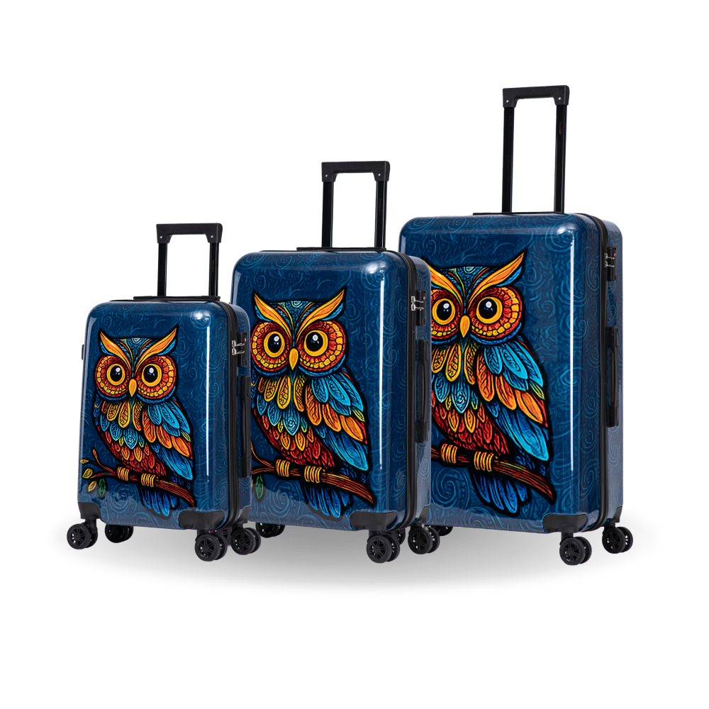 Three hard-shell spinner suitcases in blue, arranged by size, featuring a vibrant, colorful owl illustration on the front. The suitcases have black telescoping handles and are shown on a clean white background with a soft shadow.
