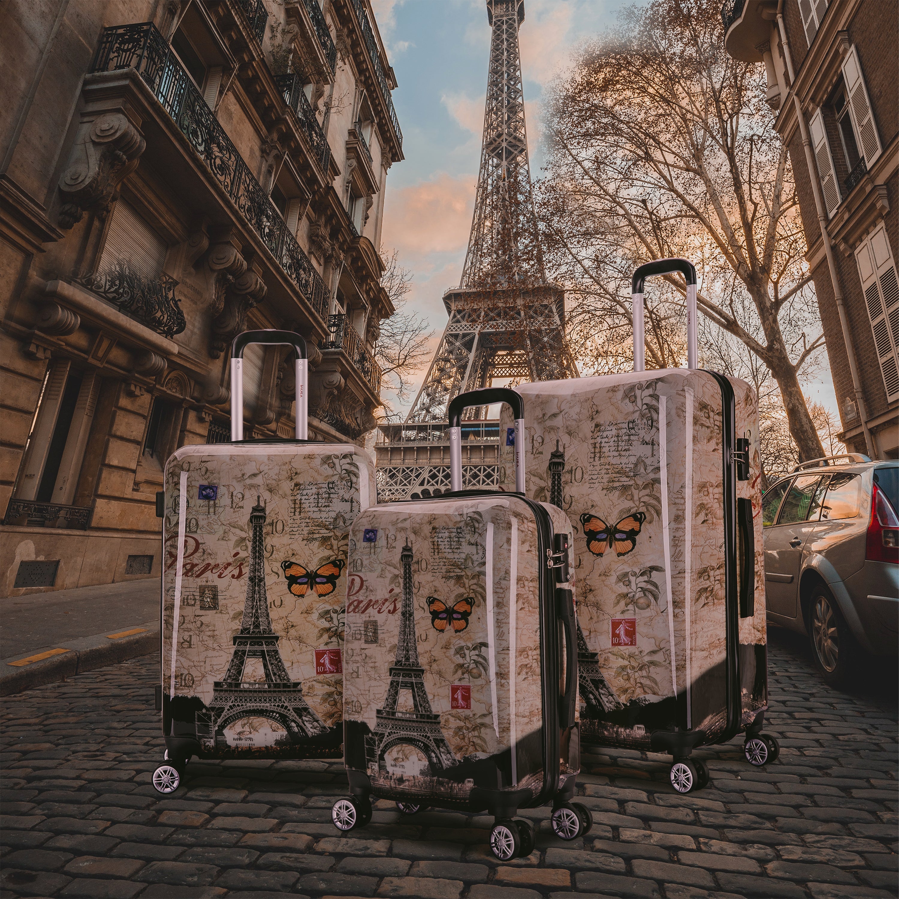 Three patterned suitcases on a street with the Eiffel Tower in the background