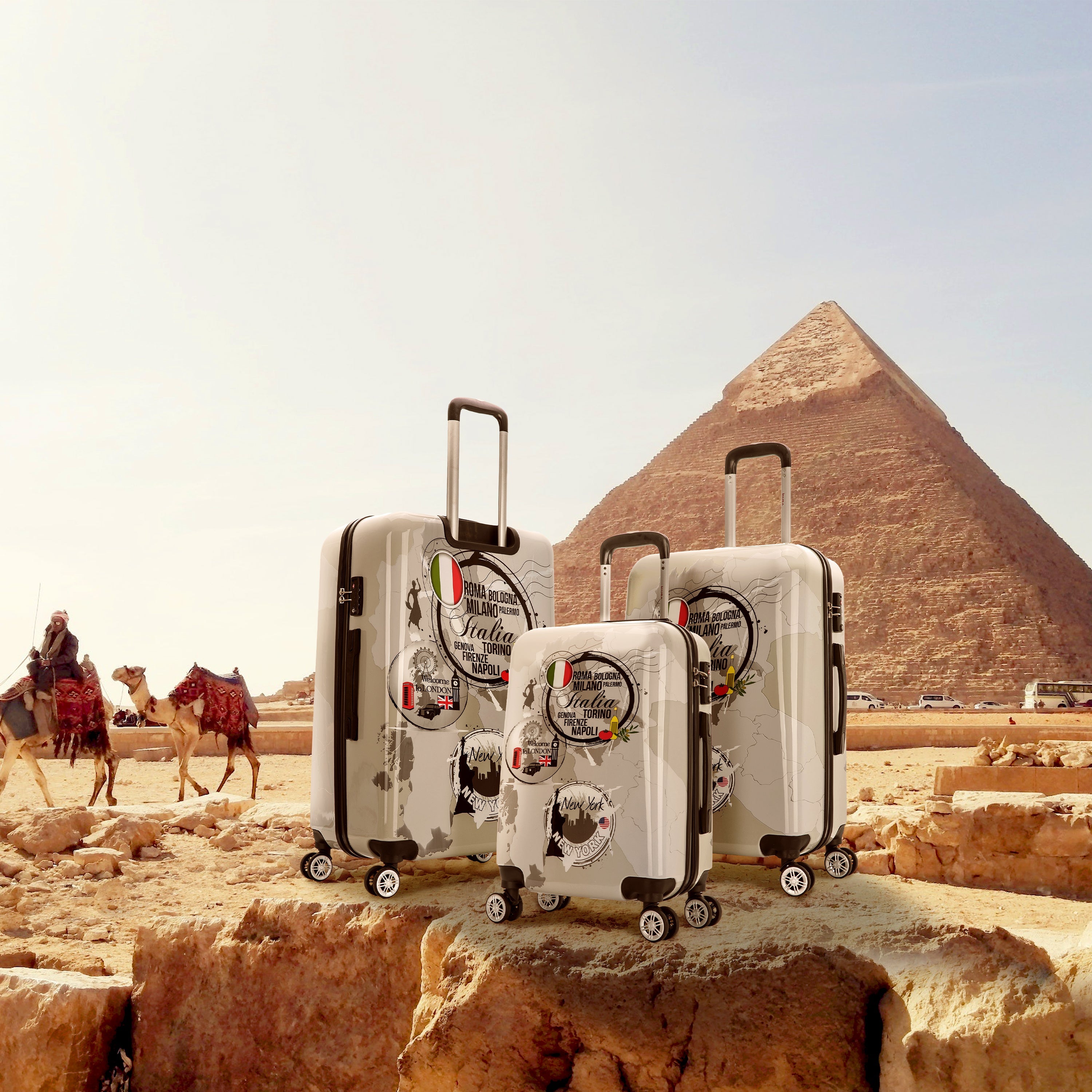 Three suitcases with travel stickers in front of a pyramid and camels in the desert.