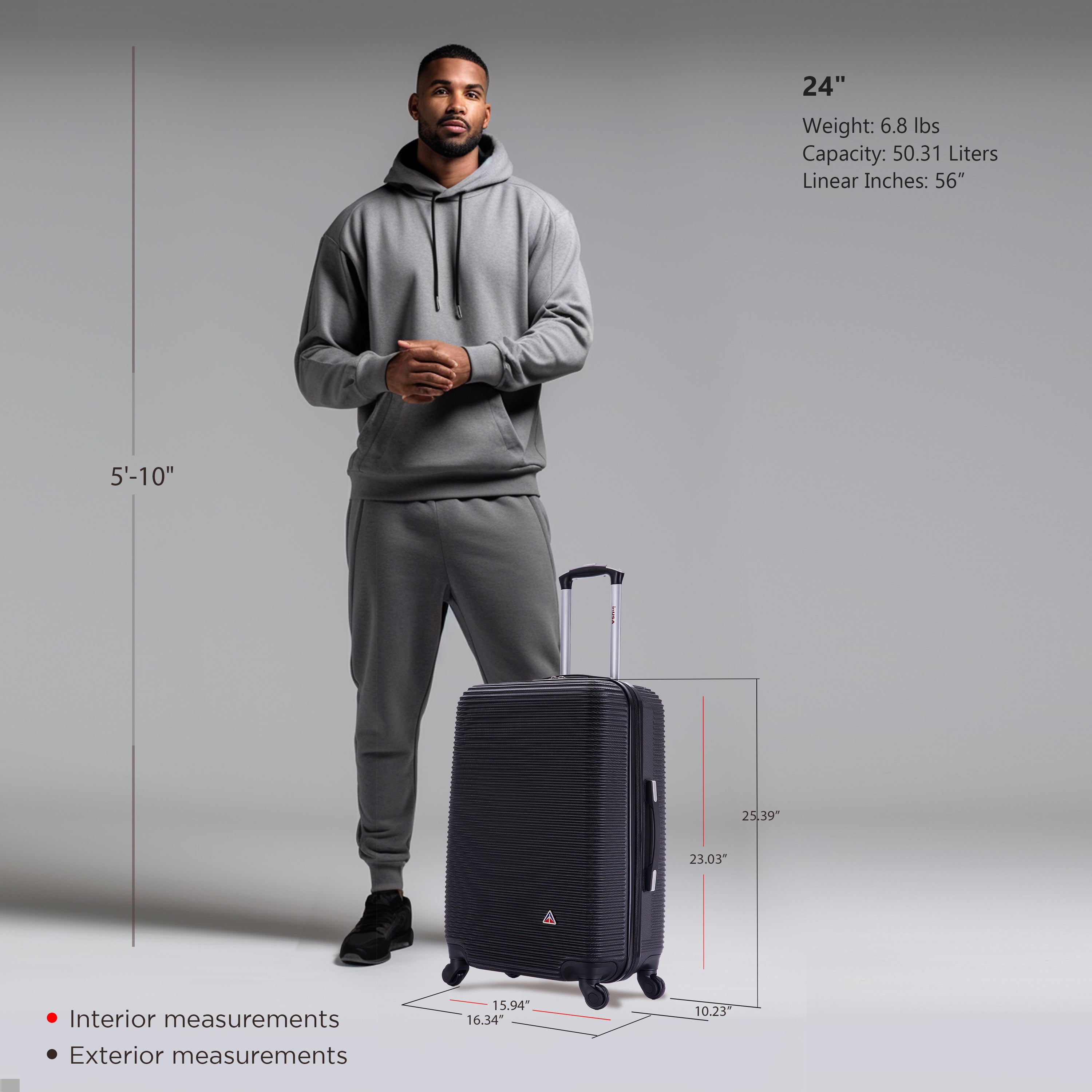 Man in gray hoodie and pants standing next to a black suitcase with measurements displayed.