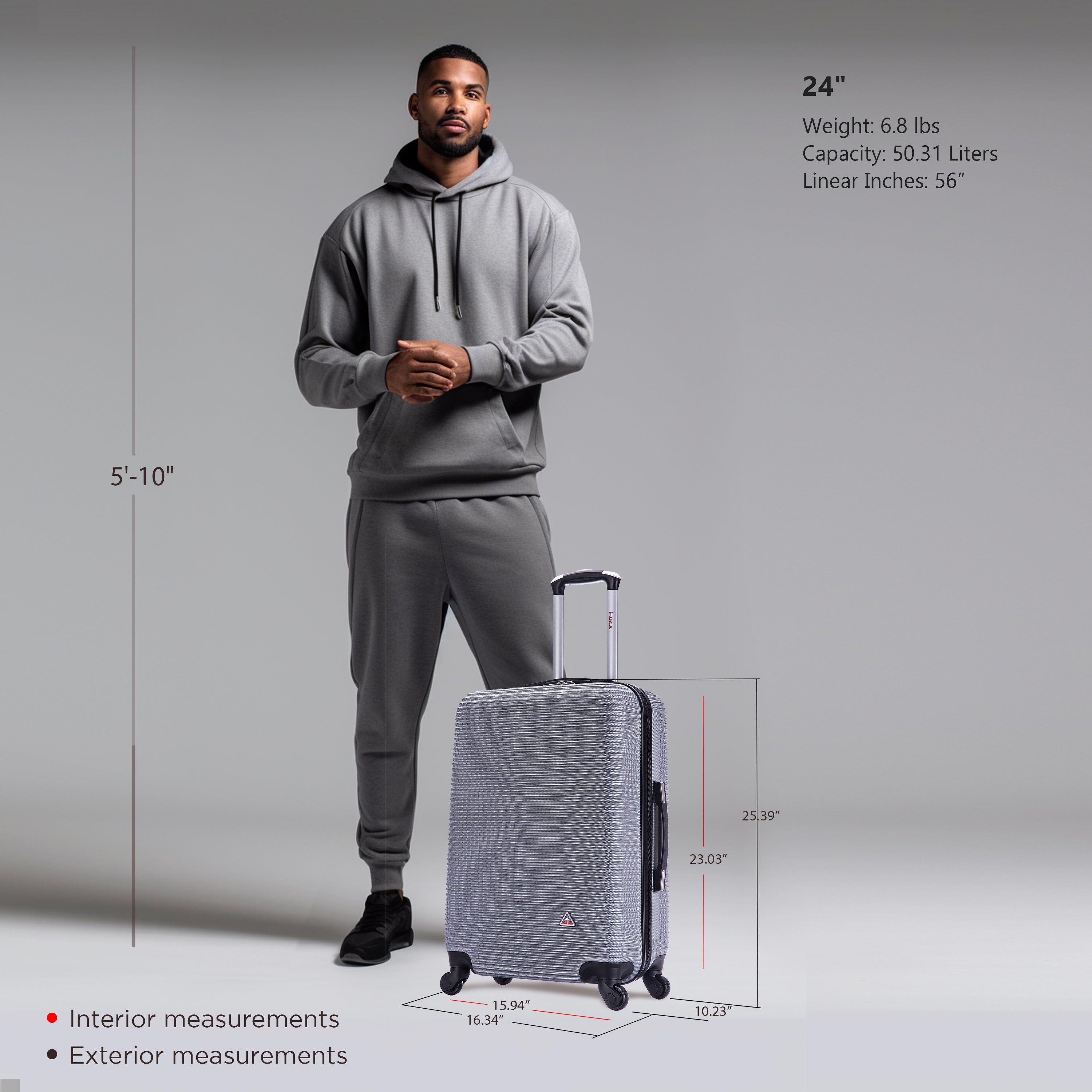 Man in gray hoodie and pants standing next to a silver suitcase with measurements displayed.