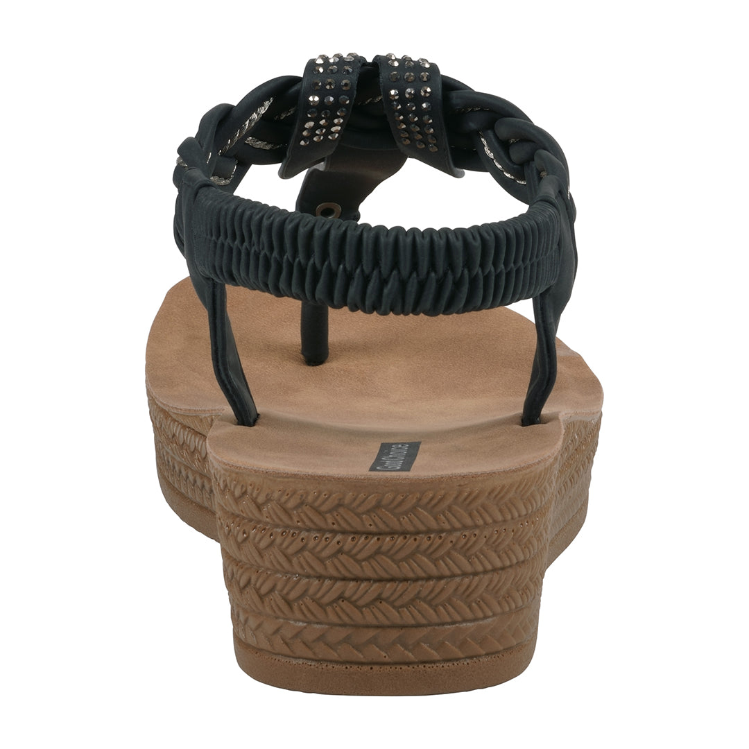Black sandal with braided design on a white background