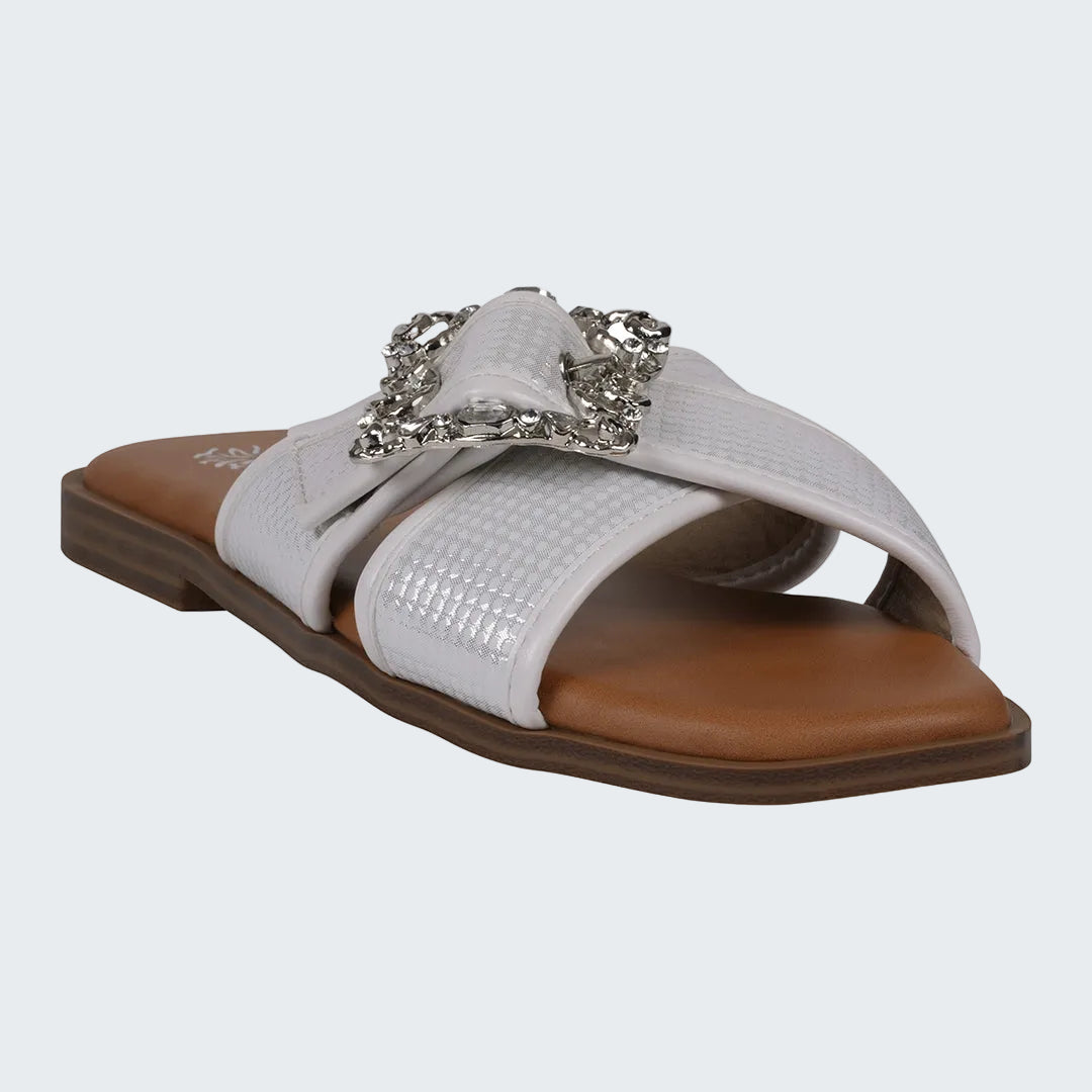 White sandal with a decorative buckle on a white background