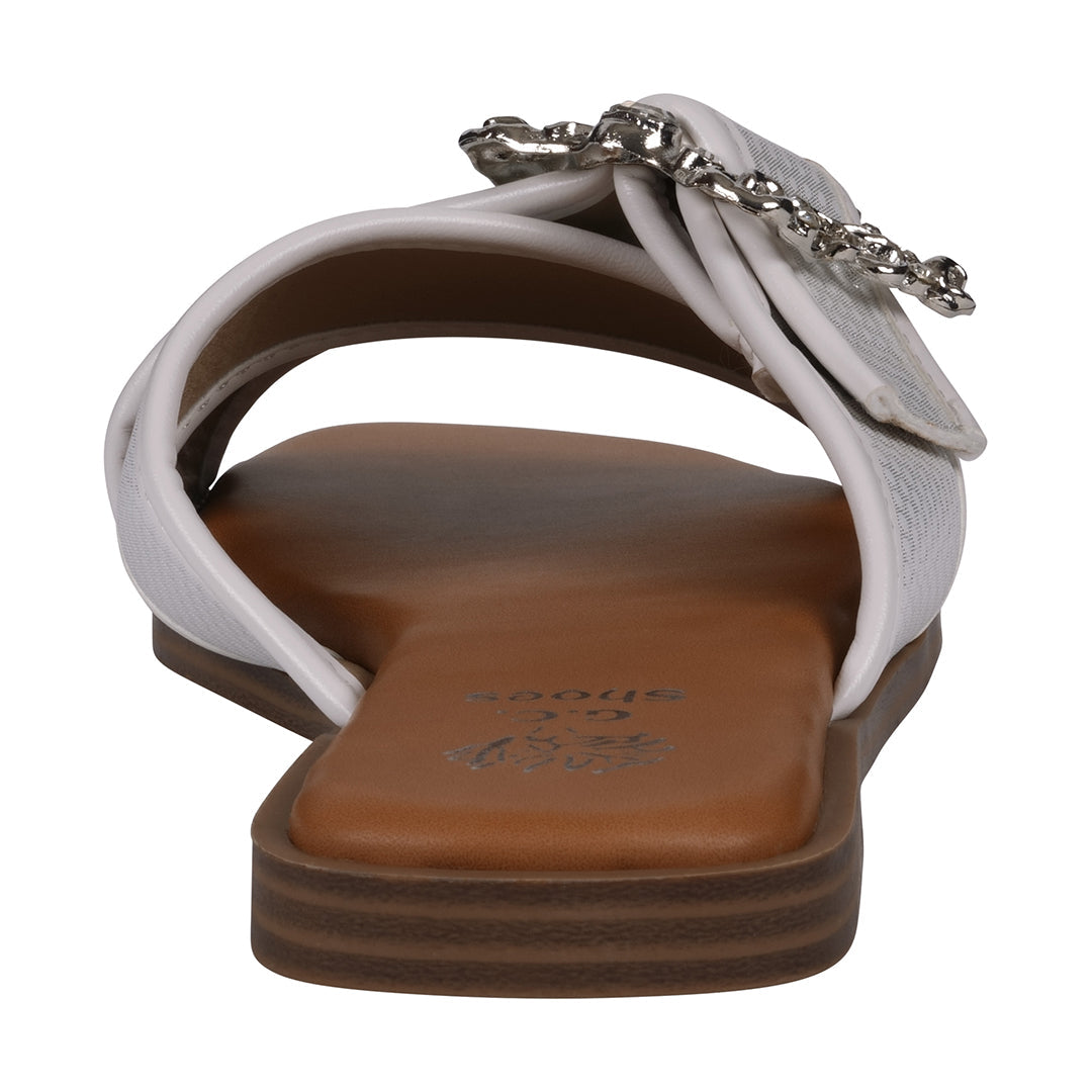 White sandal with a brown sole on a white background