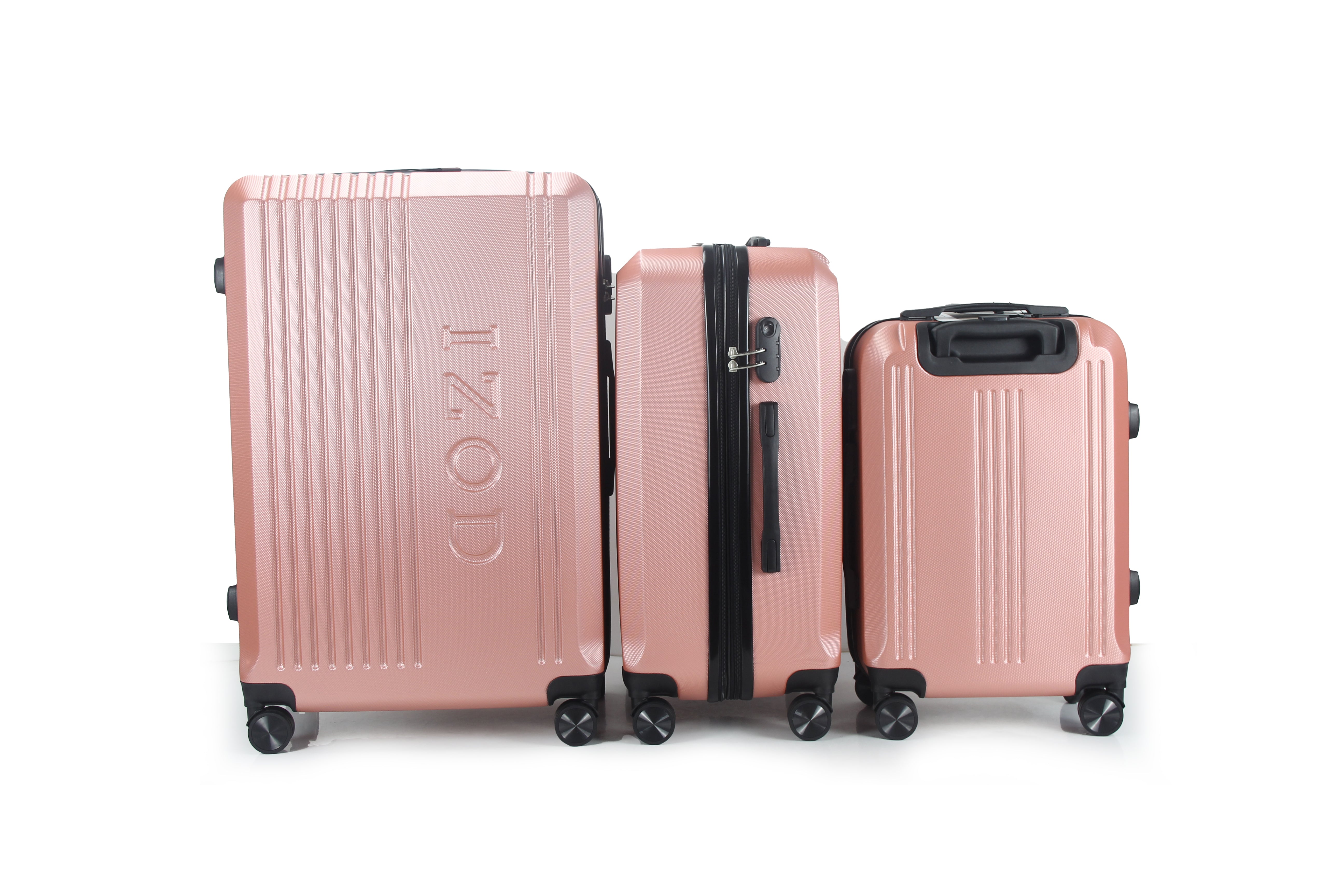 Set of three rose gold suitcases with 'IZOD' branding on a white background