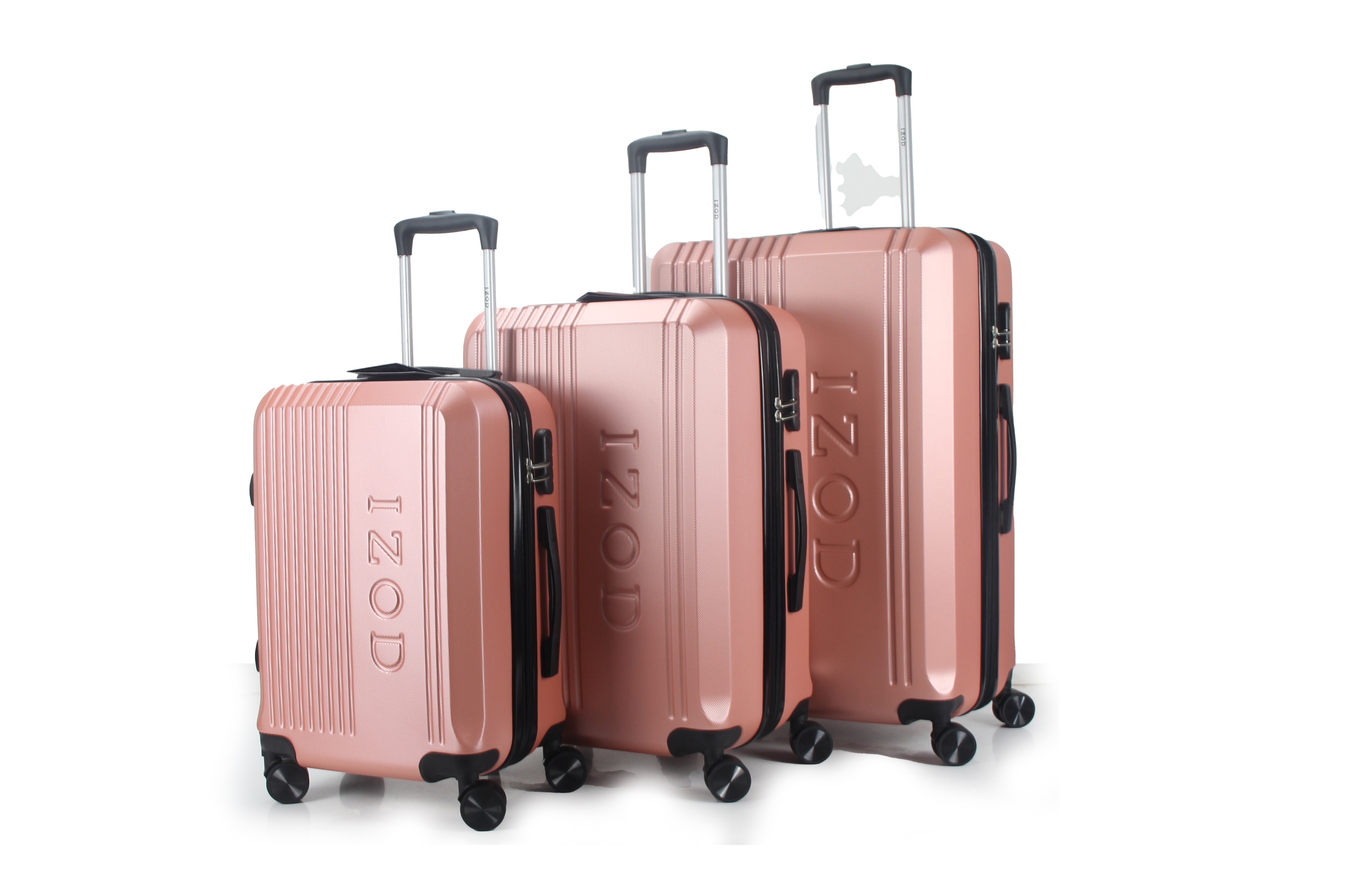 Set of rose gold suitcases with 'IZOD' branding on a white background