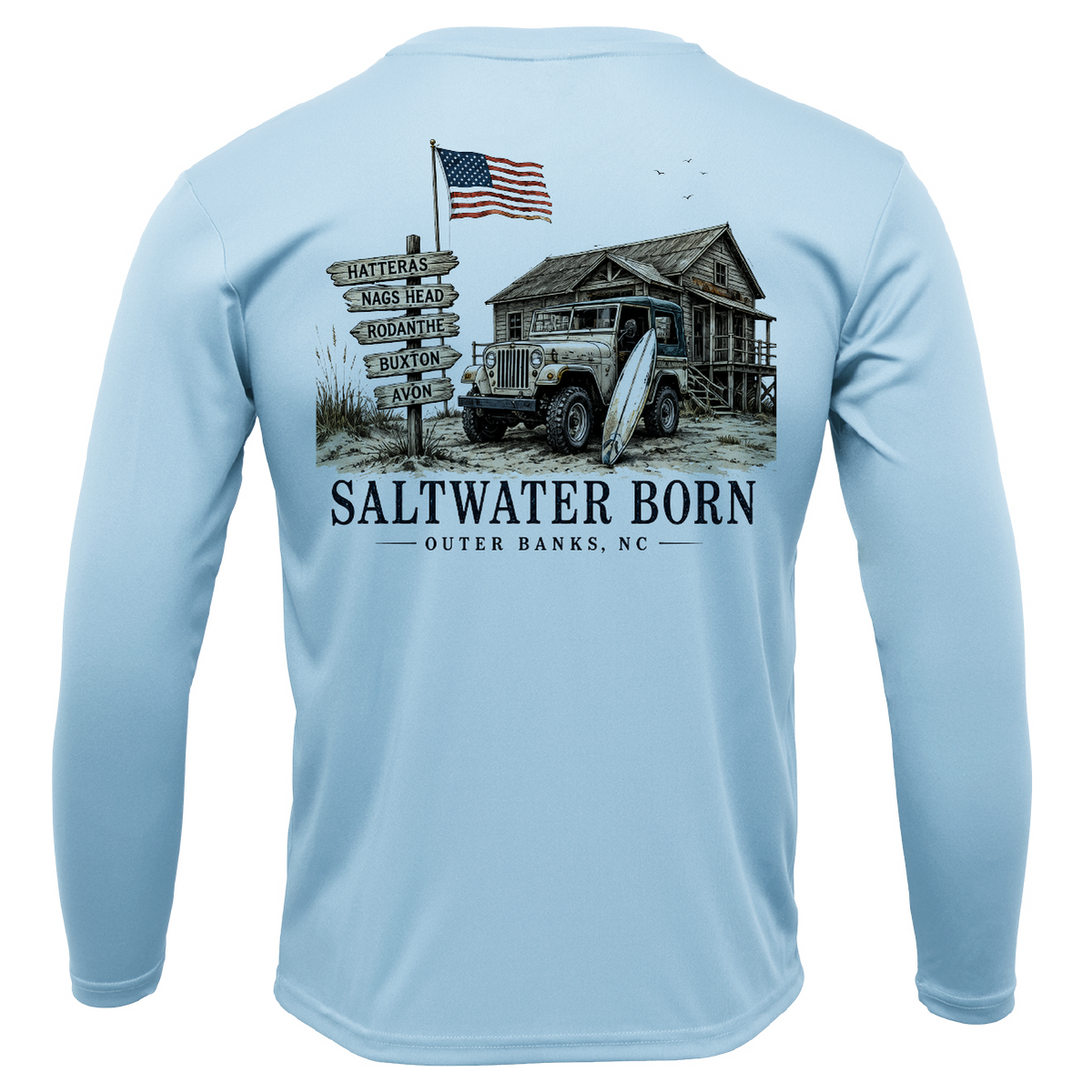 A light blue long-sleeve performance shirt shown from the back, featuring a large graphic print of a rustic cabin, vintage truck, surfboard, American flag, and a signpost reading 'SALTWATER BORN OUTER BANKS, NC'.