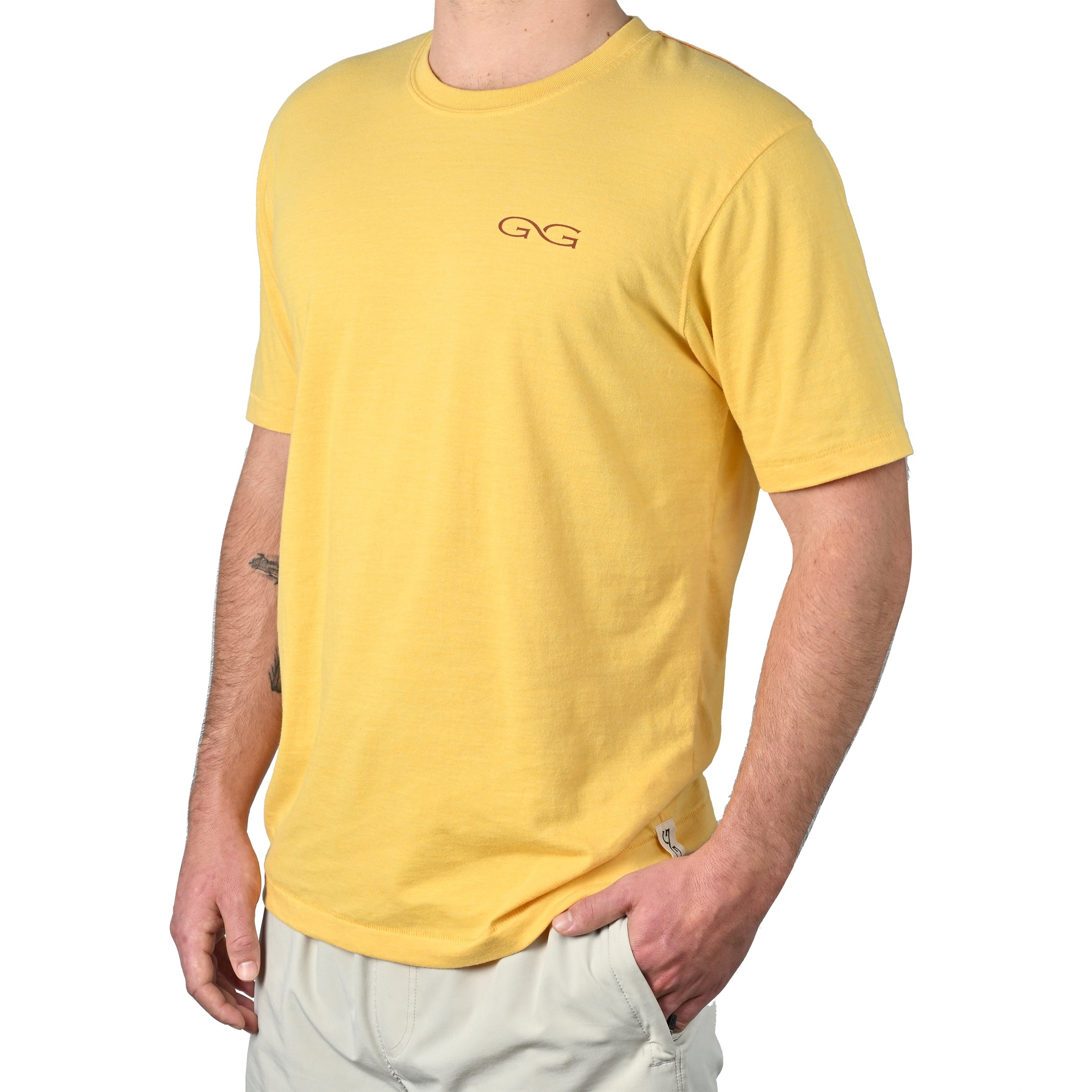 Person wearing a yellow t-shirt with a logo on a white background