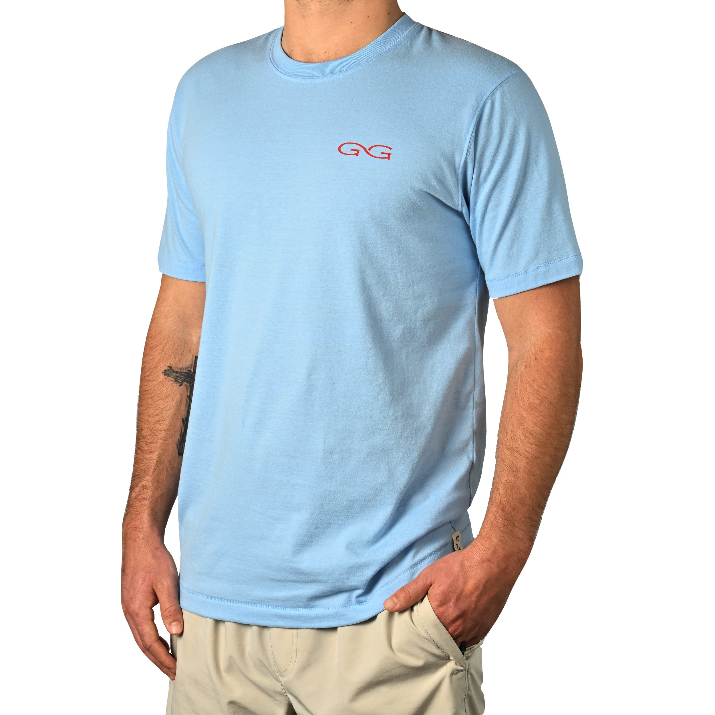 Person wearing a light blue t-shirt with a red logo on a white background