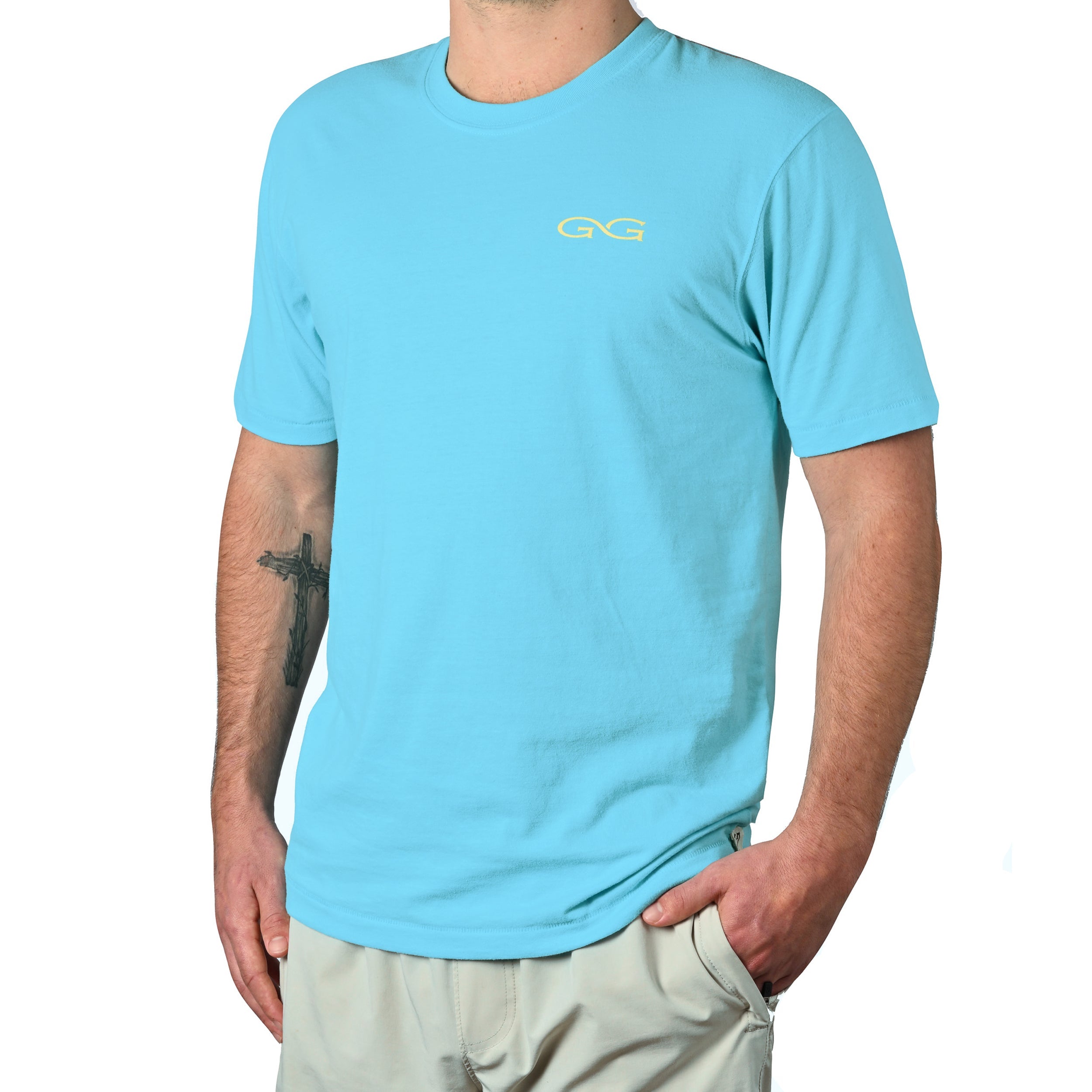 Person wearing a light blue t-shirt with a logo on a white background