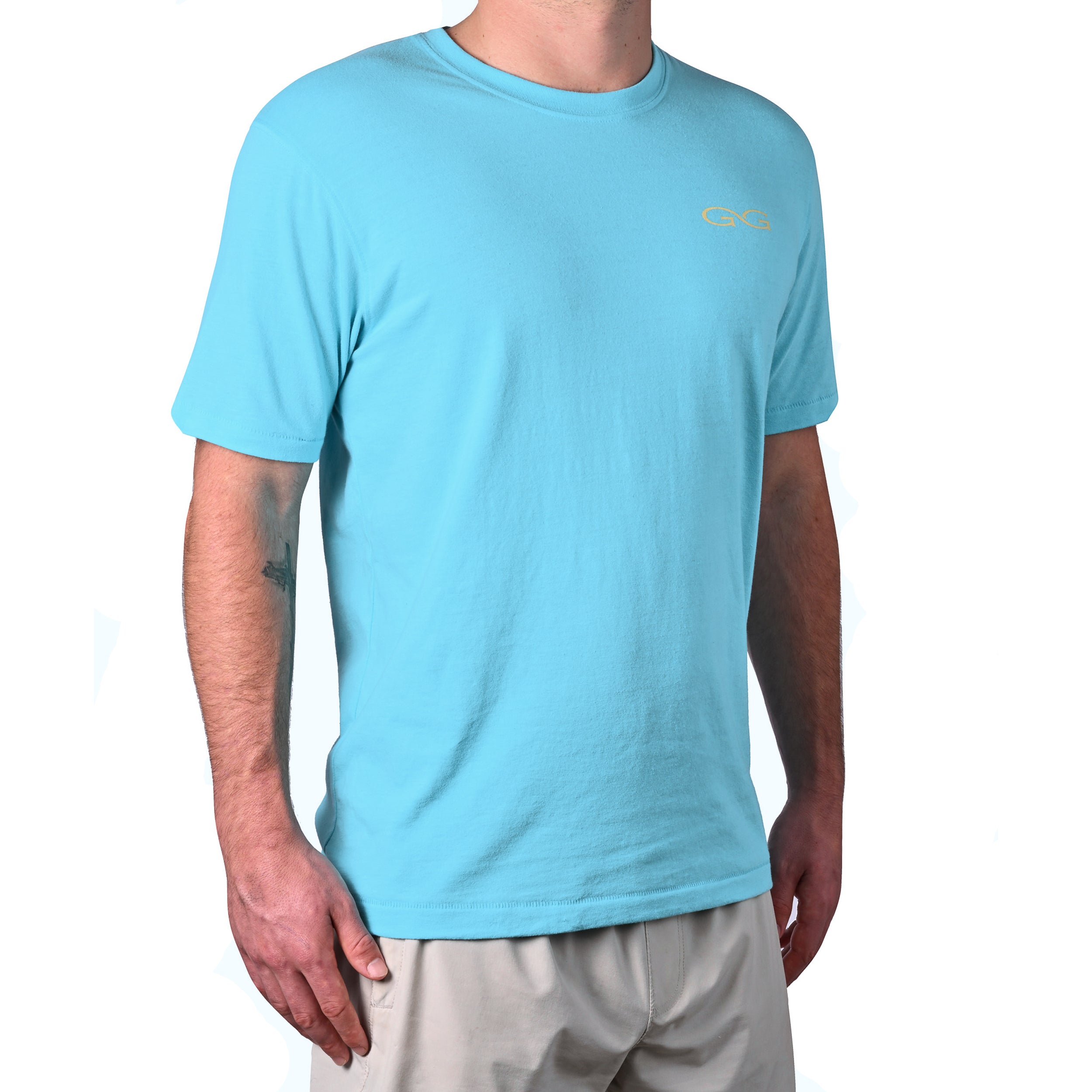 Person wearing a light blue t-shirt with a logo on a white background