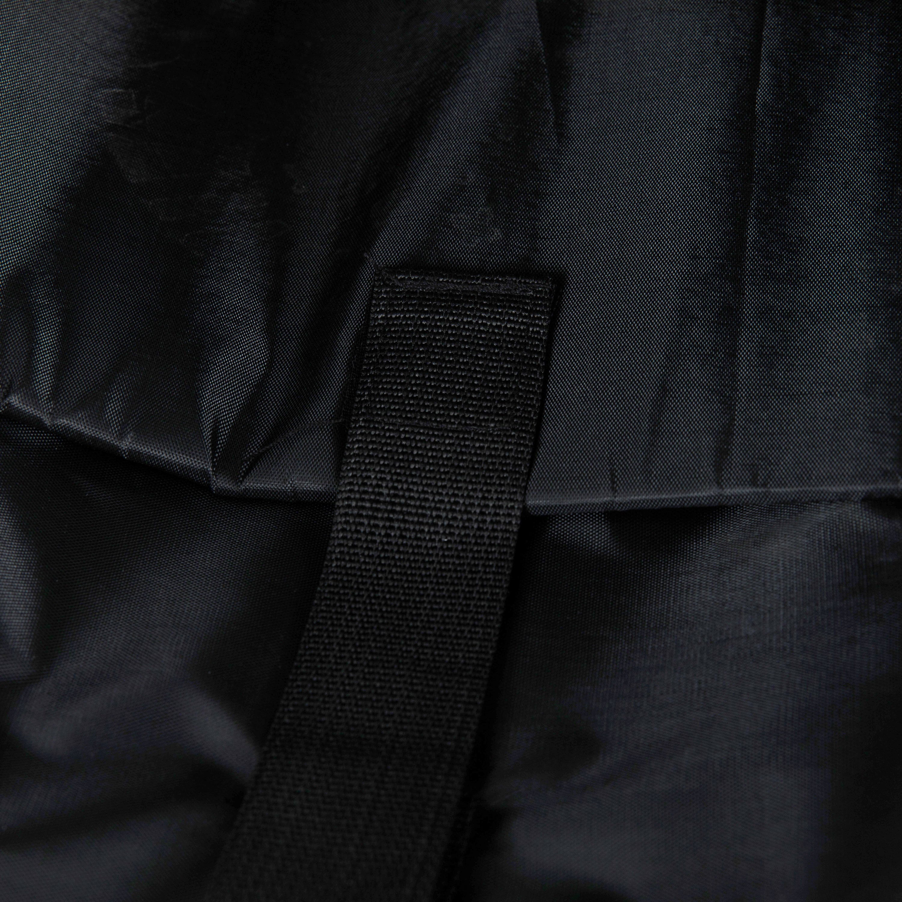 Close-up of a black backpack strap with fabric texture