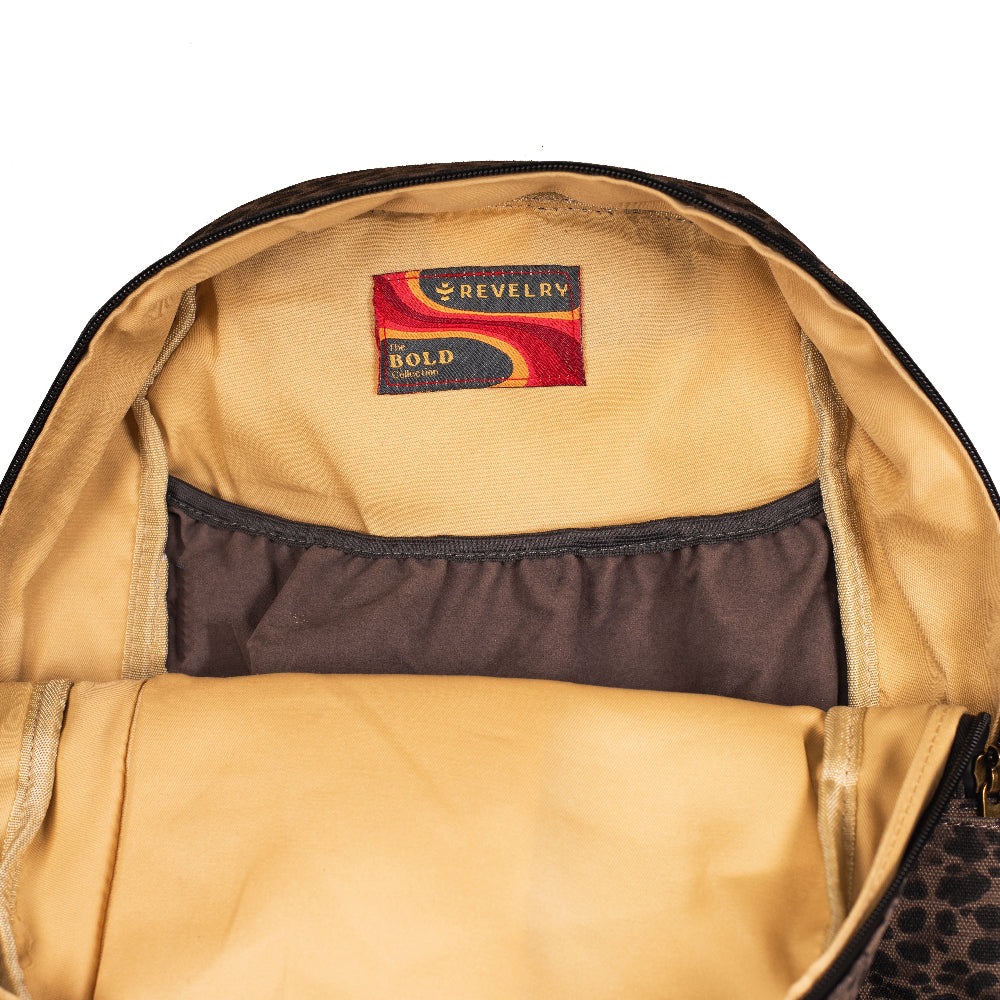 Close-up of a tan backpack interior with a visible brand label on a white background