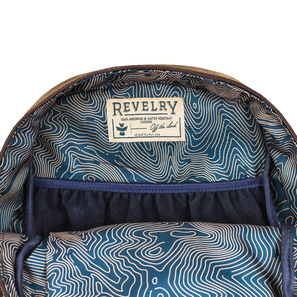 Backpack interior with topographic pattern and Revelry label on a white background
