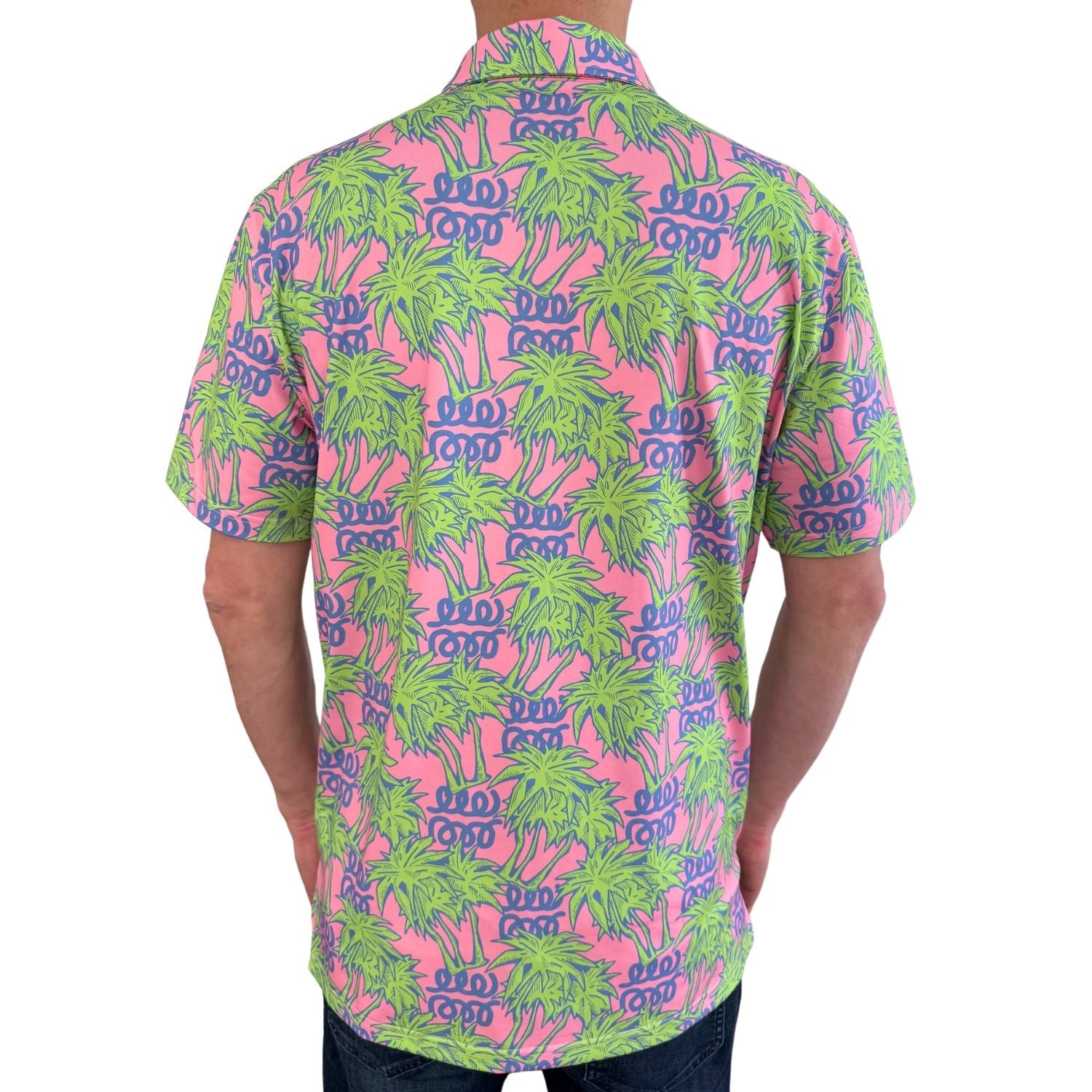 Person wearing a colorful patterned shirt with palm trees and text on a white background