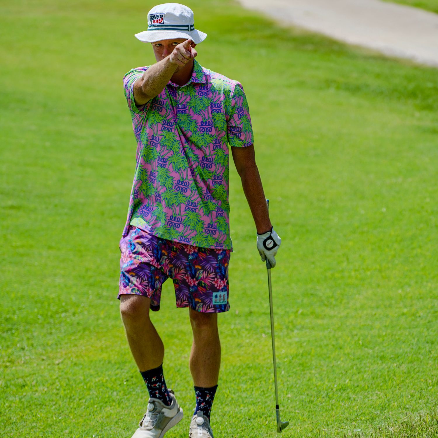 Person in colorful golf attire on a golf course