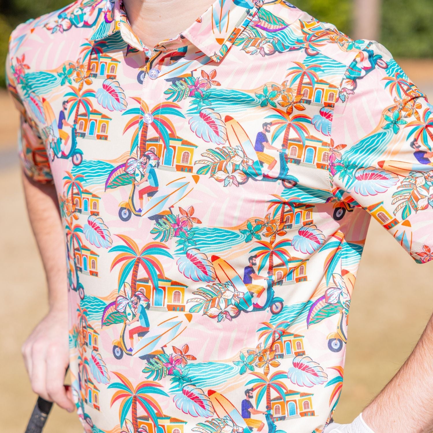 Colorful tropical-themed shirt with palm trees, beach scenes, and people on scooters.